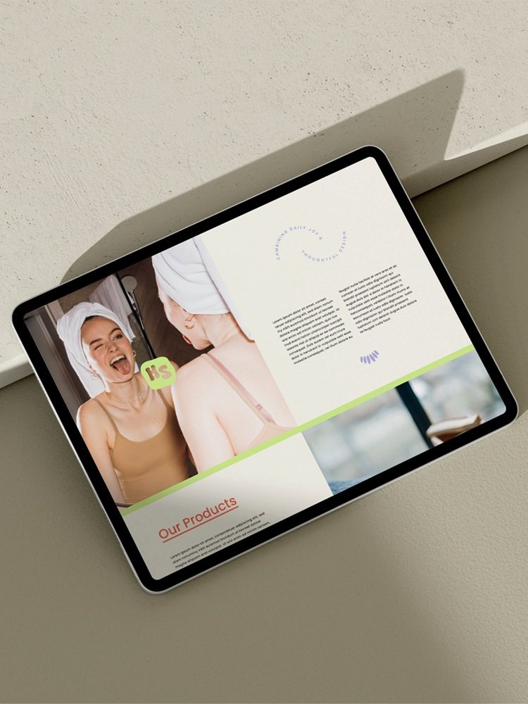 Colourful website design mock up on iPad with image of girl smiling in bathroom mirror for Hello Sundays.