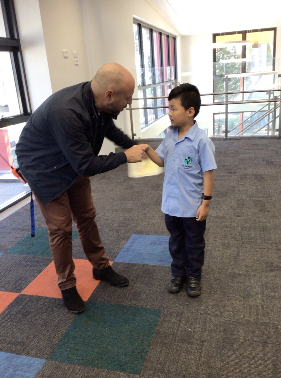 Student shaking hands with Mr Kallaras.png