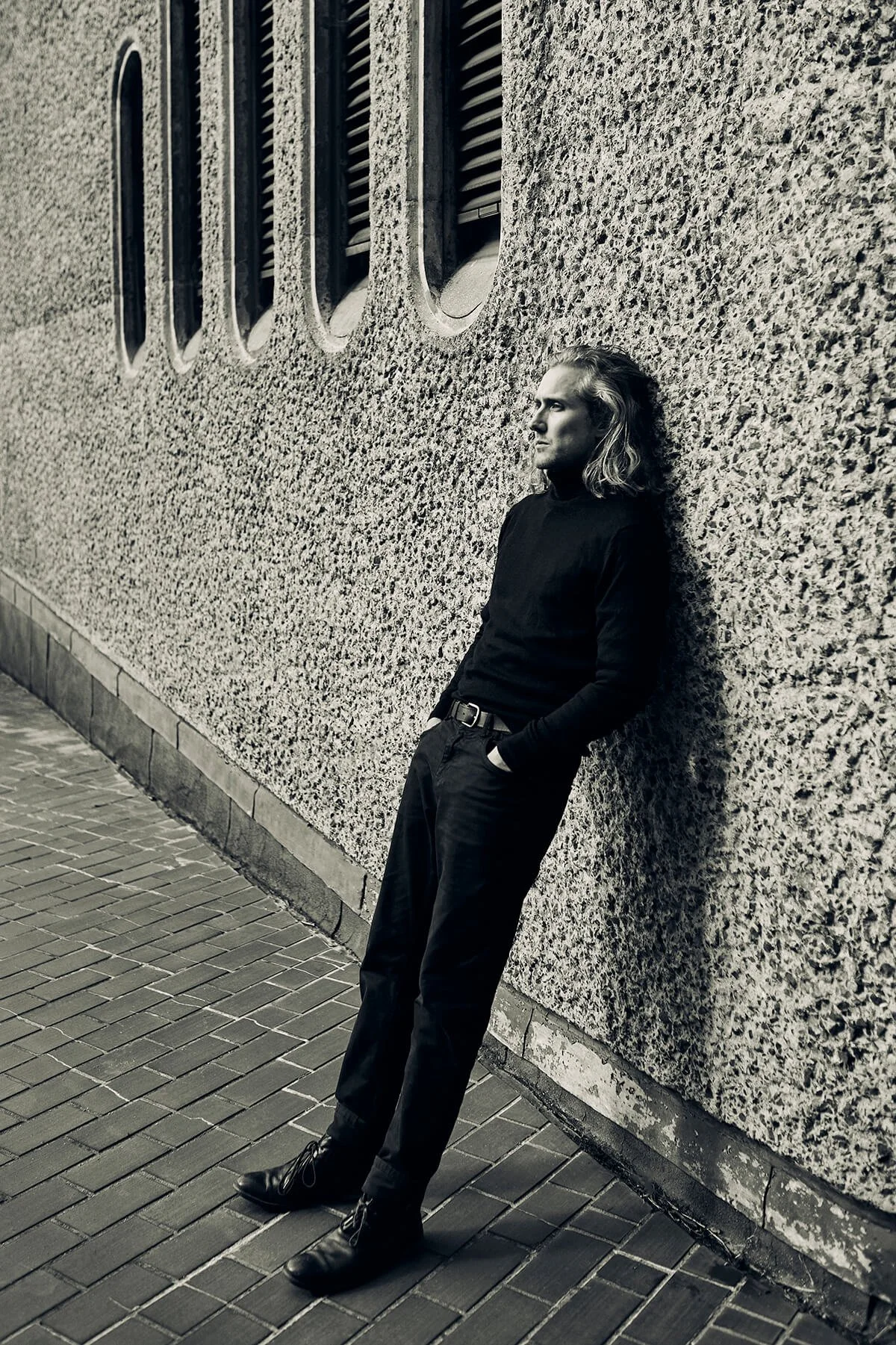 Animation director Joseph Wallace leans against a wall