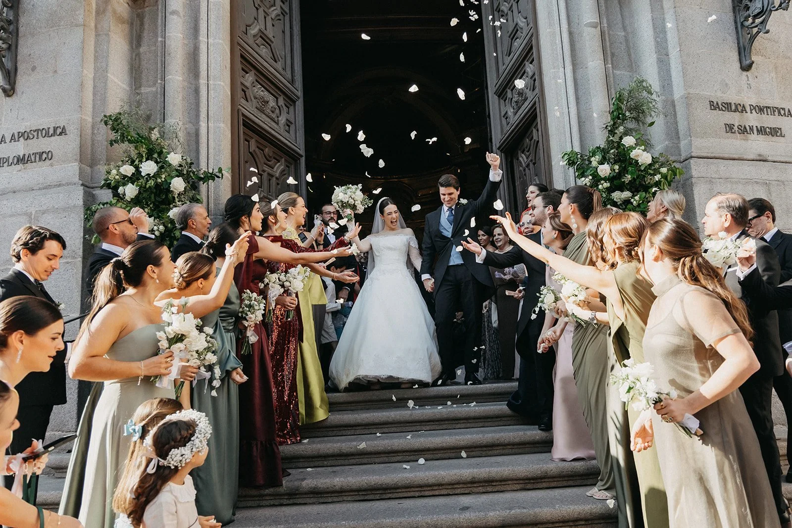 The newlyweds leaving the basilica under a shower of petals