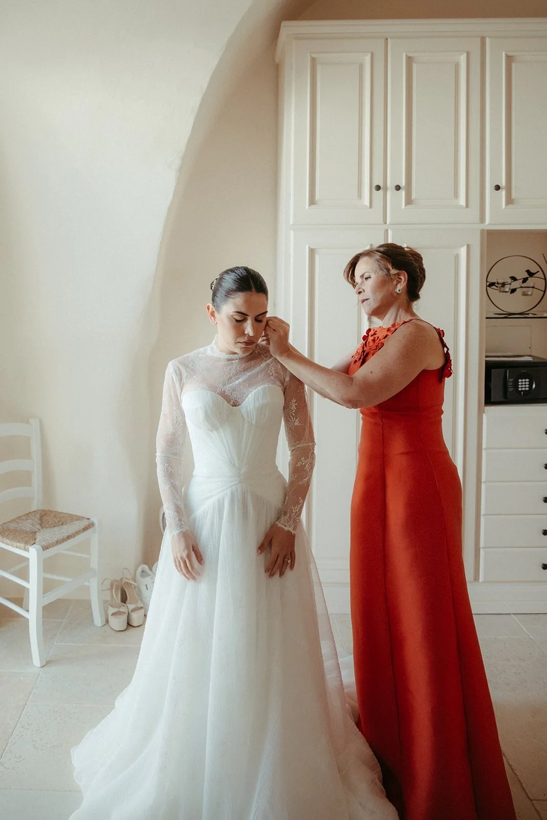 Final touches to the bride’s gown before leaving for the church