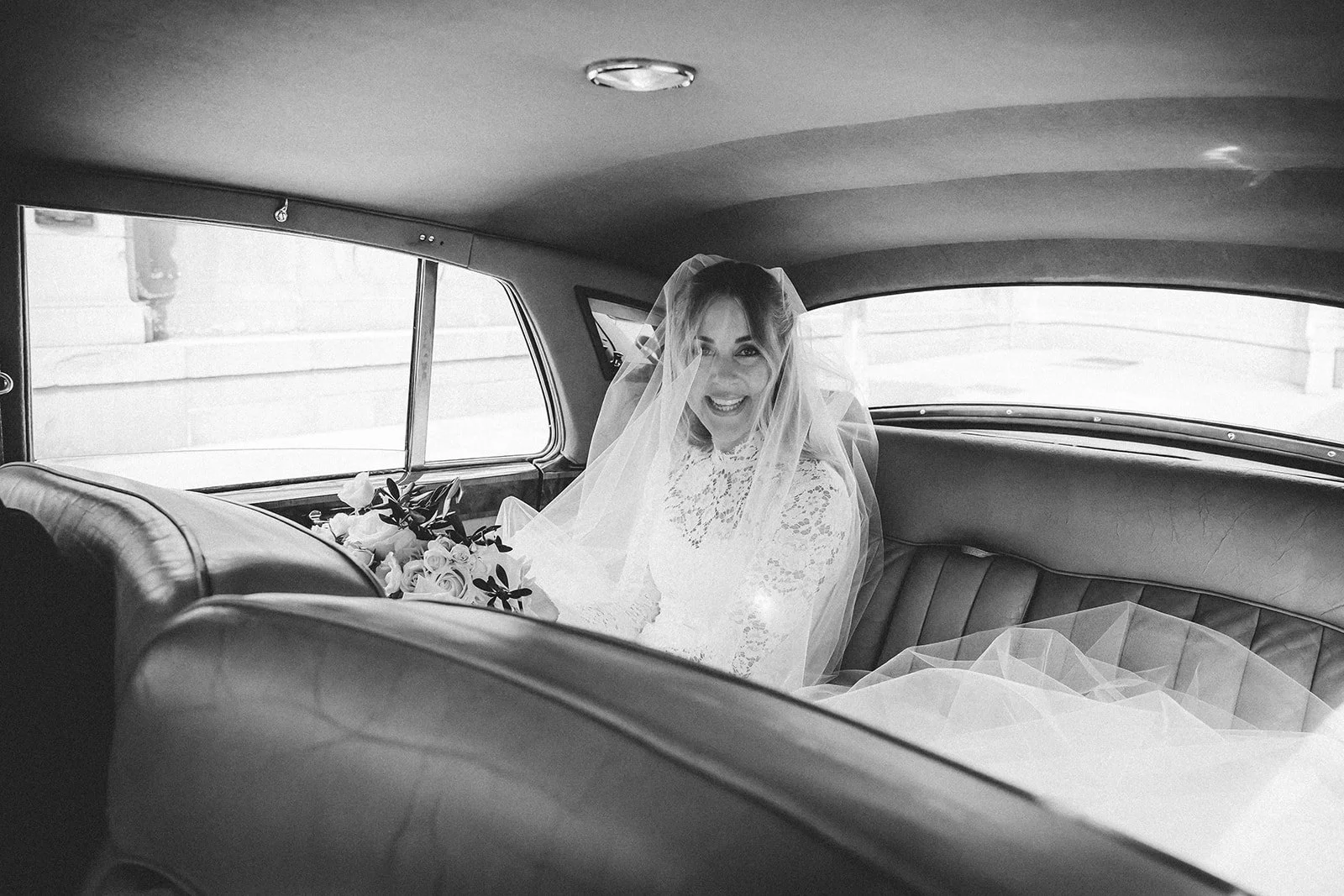 Marina in the back seat of the car on the way to church, in black and white