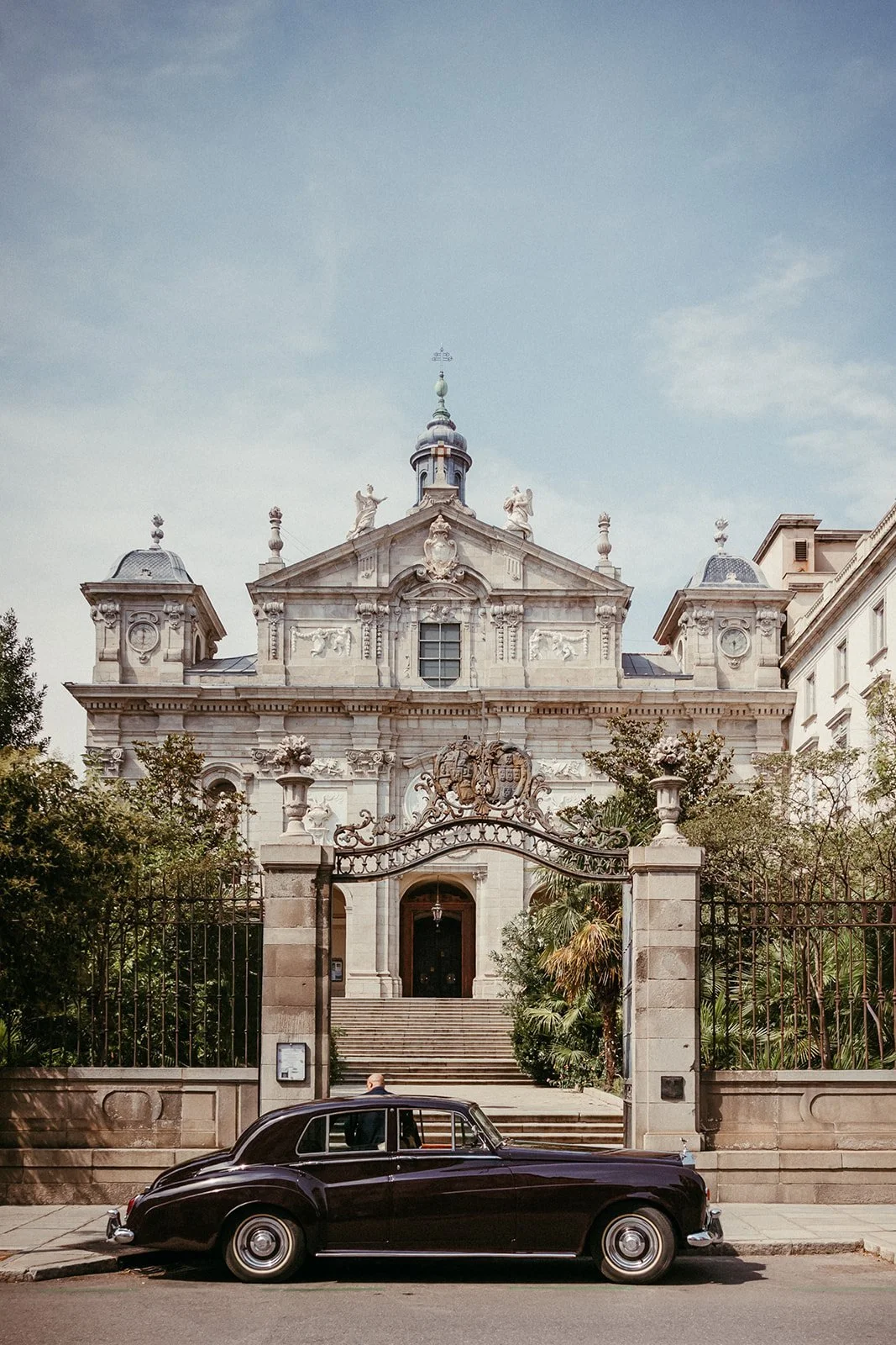 Façade of Santa Bárbara church in the Salesas Reales with the wedding car at the gate