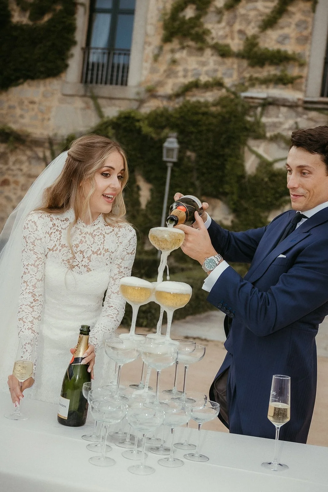 The couple pouring the champagne tower at the cocktail