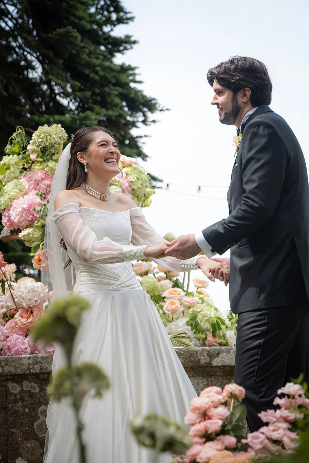 Los novios durante la ceremonia en un jardín de Galicia
