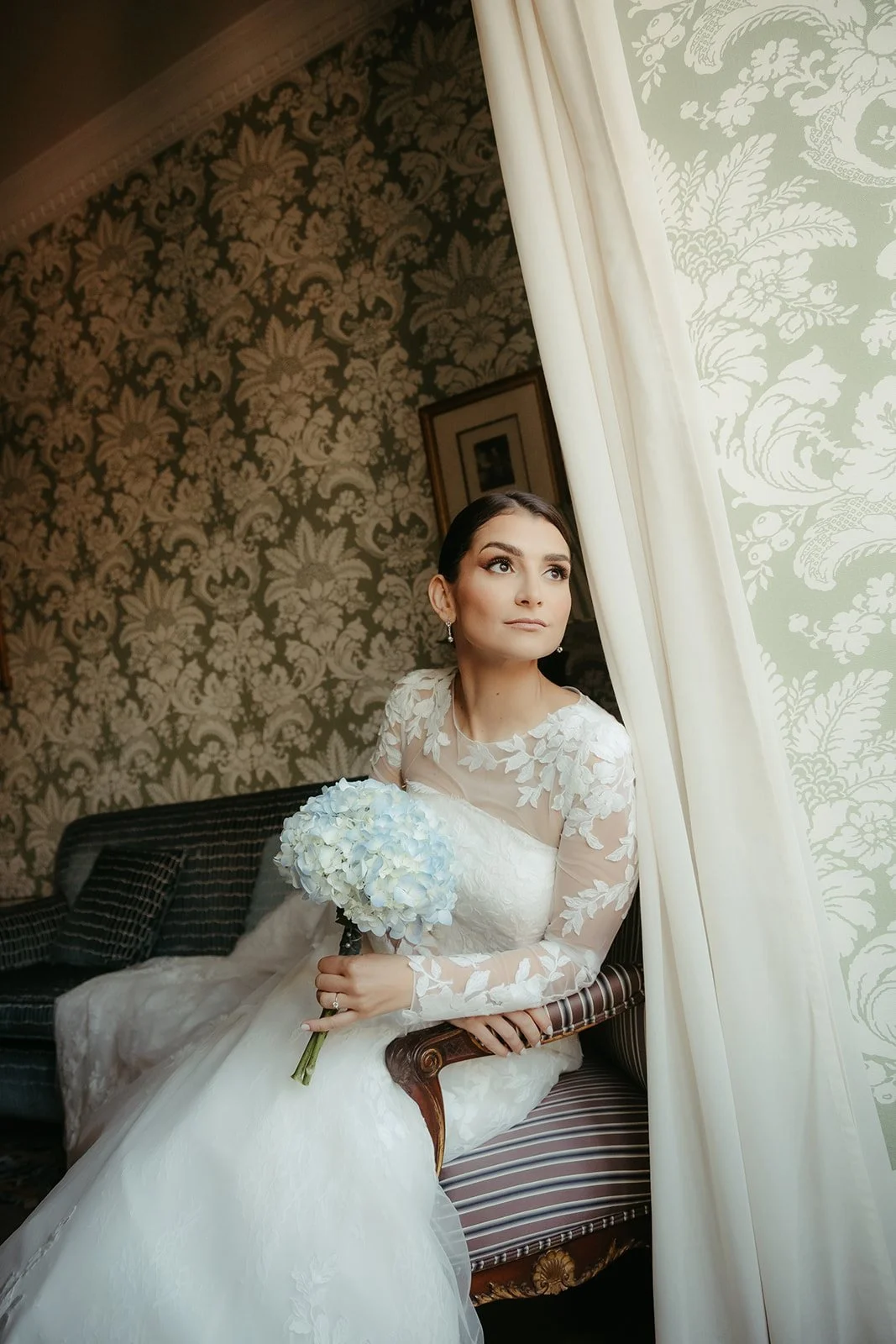 Bride by the window in soft natural light before her Madrid wedding