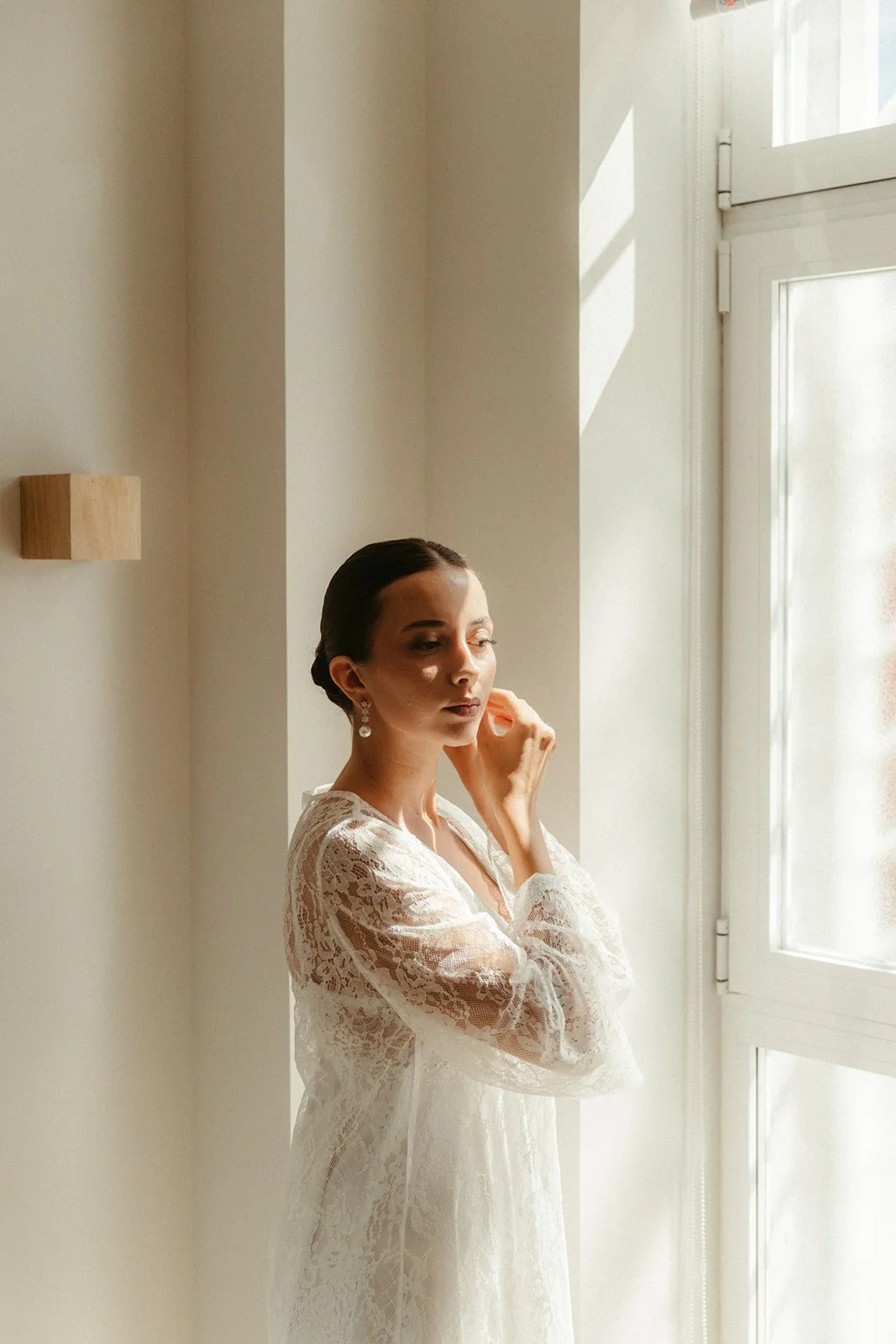 Bride getting ready in window light, Madrid