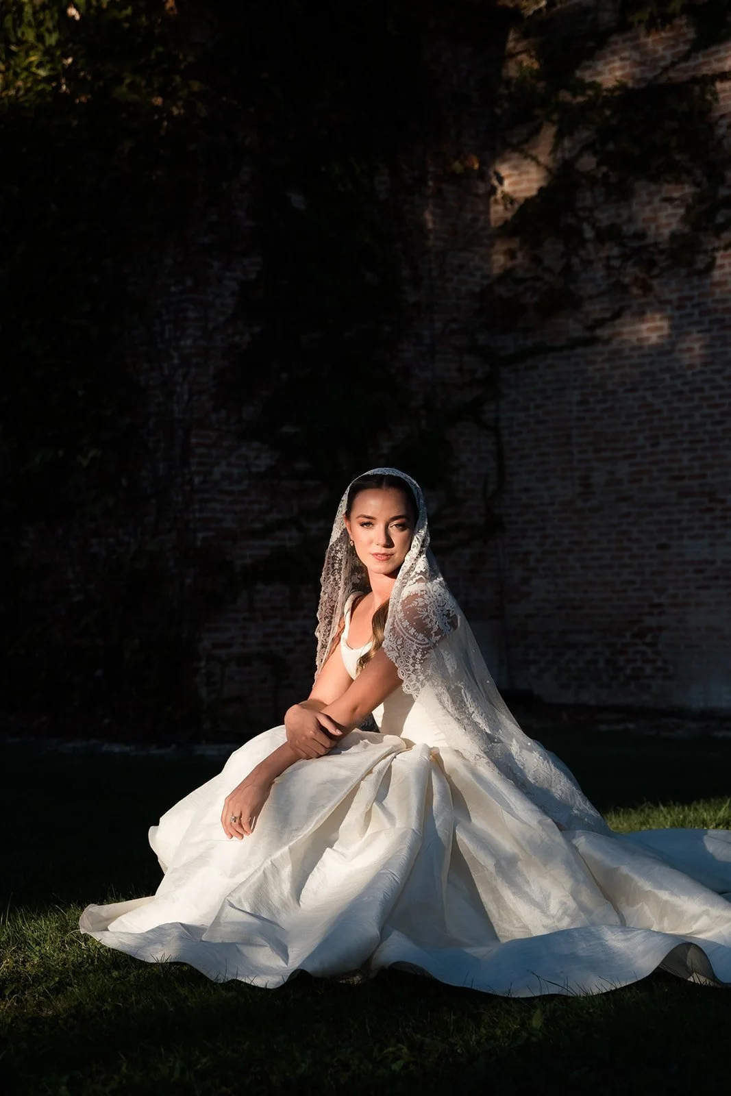 Evening portrait of a bride in her gown in a Madrid garden