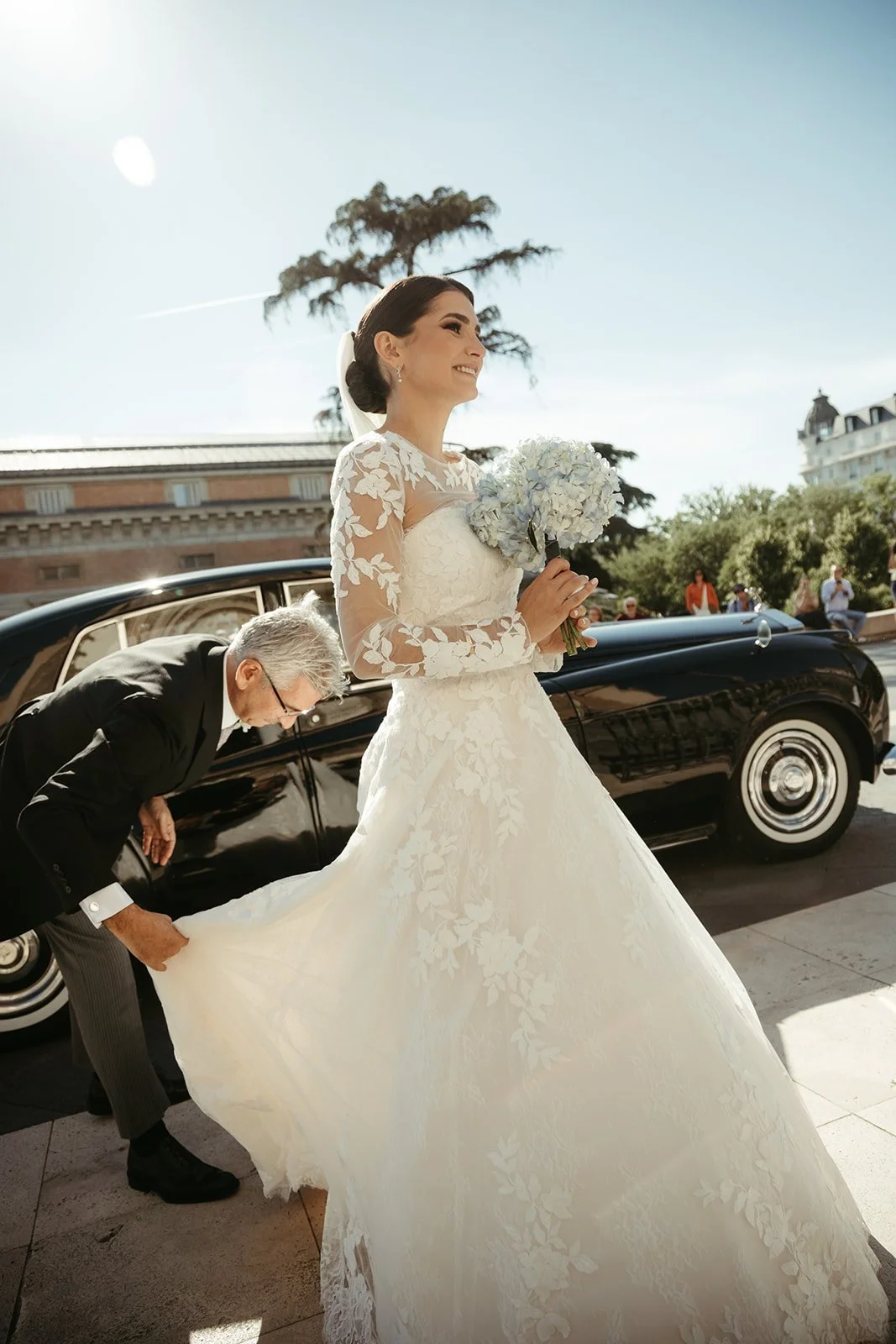 Bride stepping out of a vintage car at San Jerónimo el Real church, Madrid