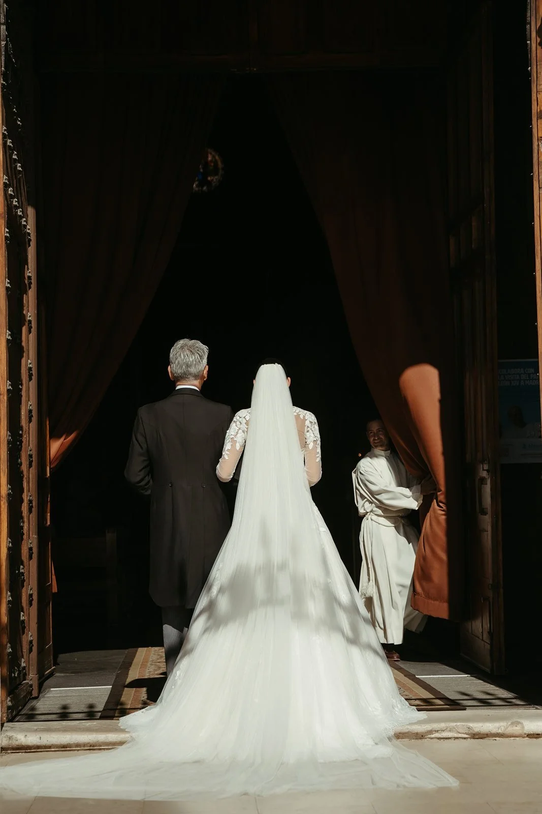 Bride entering San Jerónimo el Real church on her father’s arm, Madrid