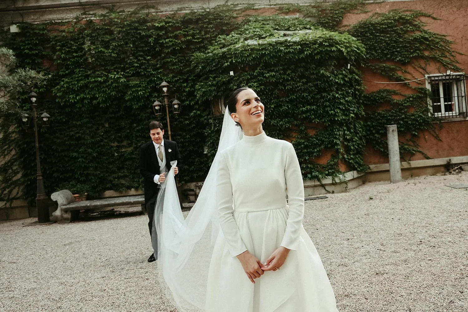 Bride in a high-neck gown in the gardens of La Casa de Mónico, Madrid