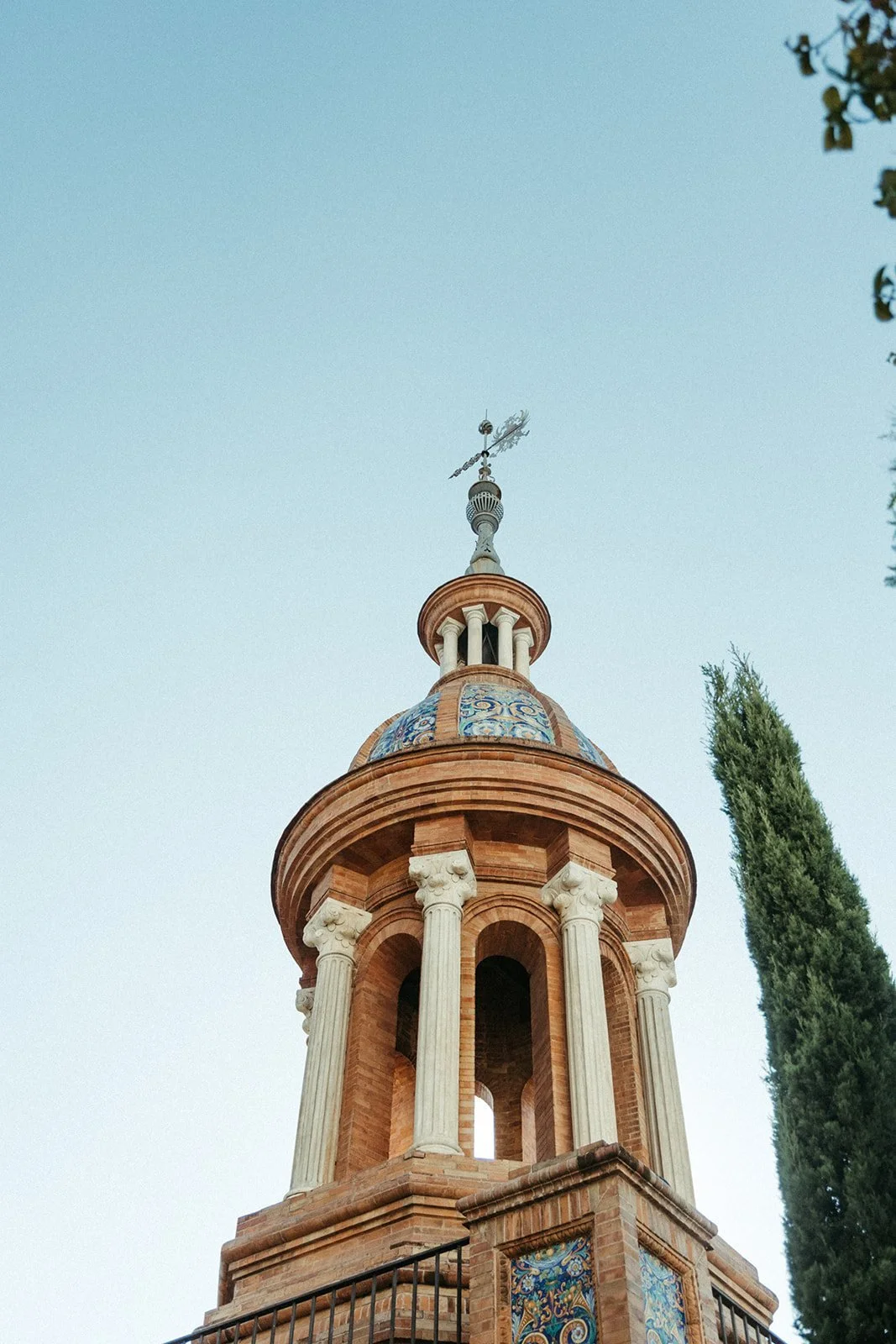 Church bell tower against a blue sky on a wedding day in Madrid