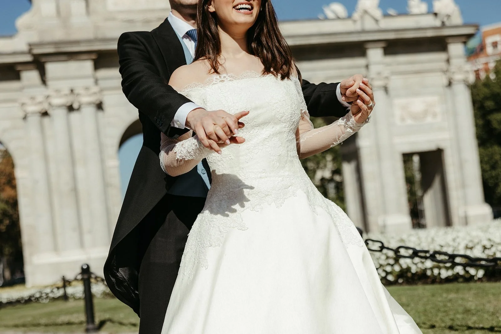 The couple in front of a monumental stone gate during their post-wedding session