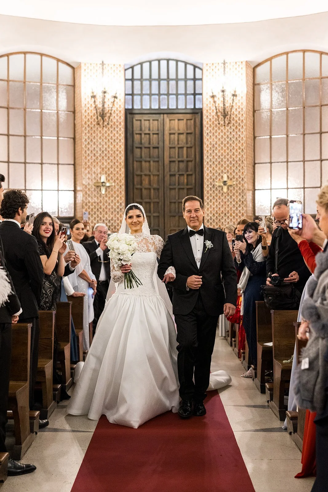 Bride walking down the aisle on her father’s arm at a church wedding in Madrid