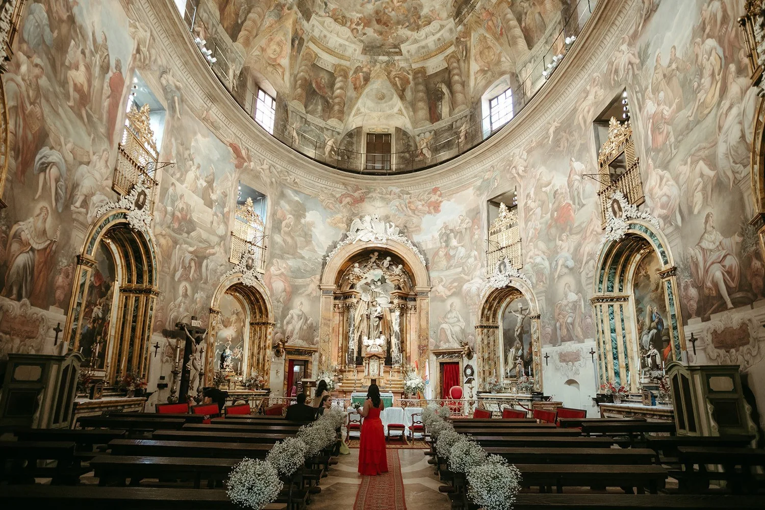 The frescoed church of San Antonio de los Alemanes in Madrid, decorated with baby’s breath for a wedding ceremony