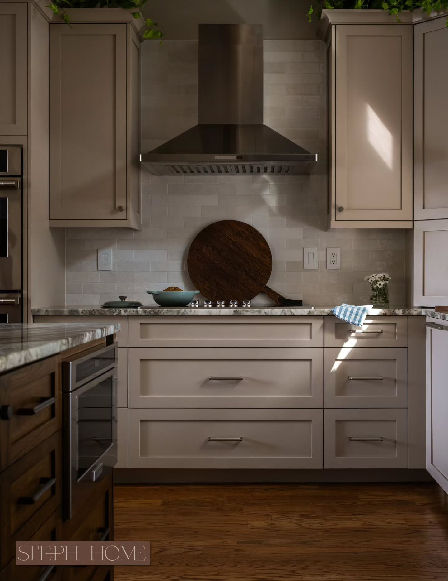 This kitchen used to feel dated, dingy, and a little disconnected from the view.

New finishes helped but lighting was the main fix.

We opened up sightlines to the water and front yard, then layered the artificial lighting to work with it instead of