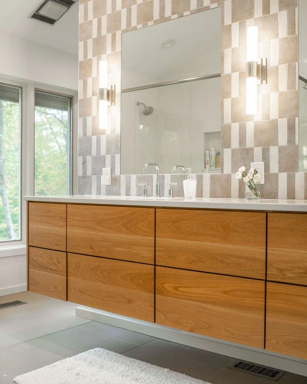 This mid-century home got a refresh. 

The graphic checkered tile brings the energy. The floating oak vanity keeps things light and warm, and nods to the era without turning the bathroom into a costume.

Sometimes the most thoughtful move is knowing 