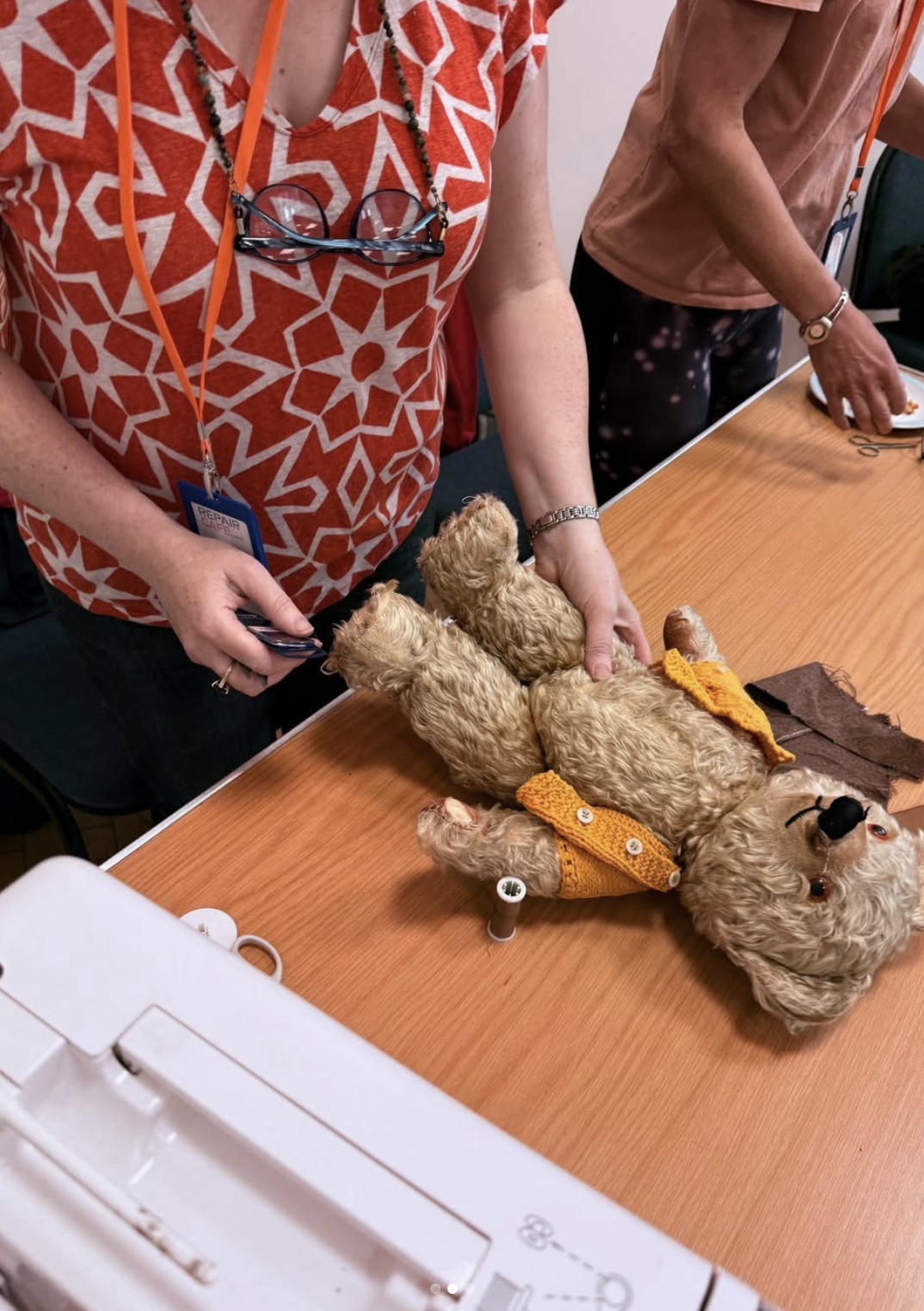 Volunteer sewing and repairing a teddy bear at Lymm Repair Café