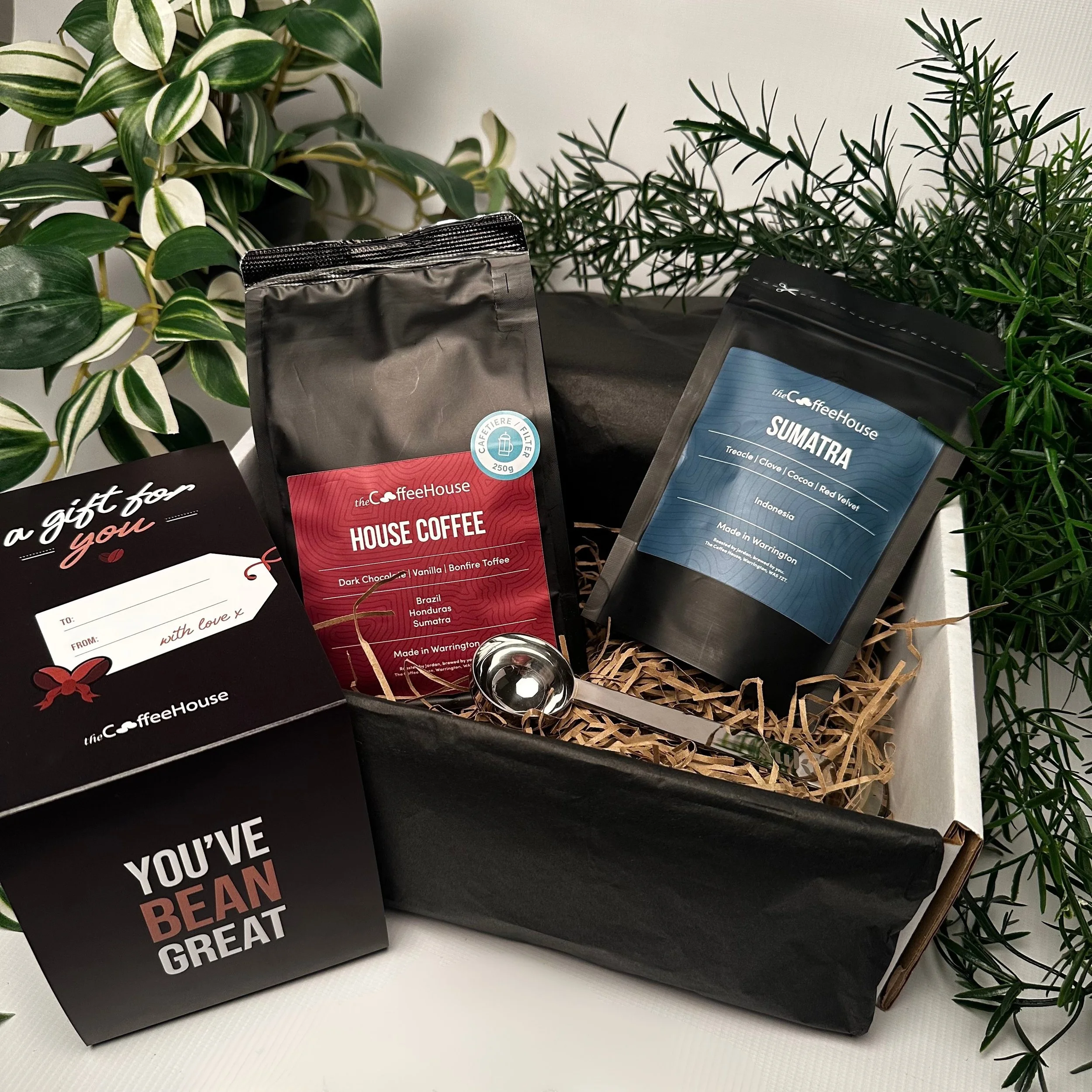 A Fathers Day gift box from The Coffee House featuring two coffee bags—one labeled “House Coffee” with tasting notes of dark chocolate, vanilla, and bonfire toffee, and another labeled “Sumatra” with notes of treacle, clove, cocoa, and red velvet.