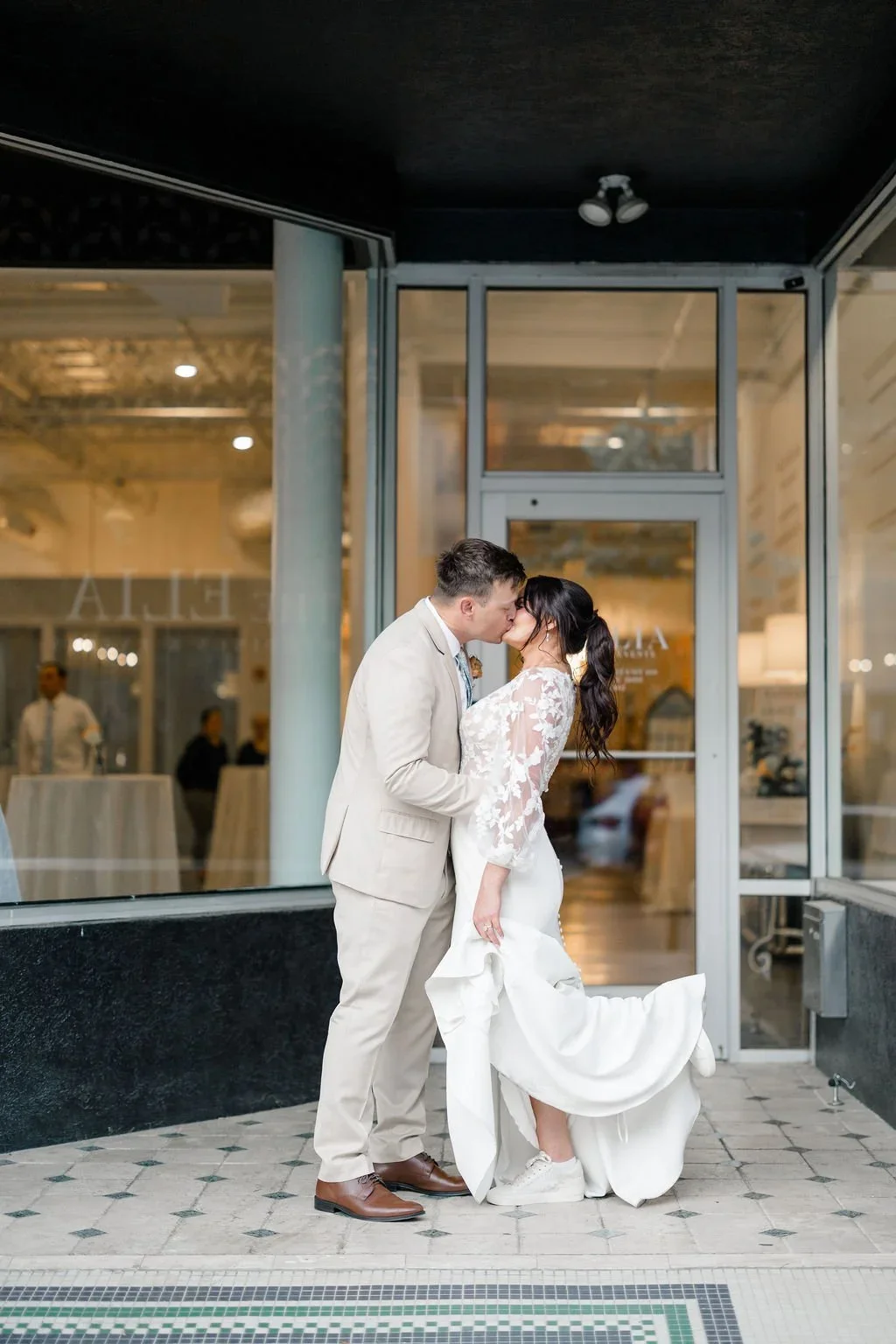 Bride and groom kiss in front of coastal NC wedding venue