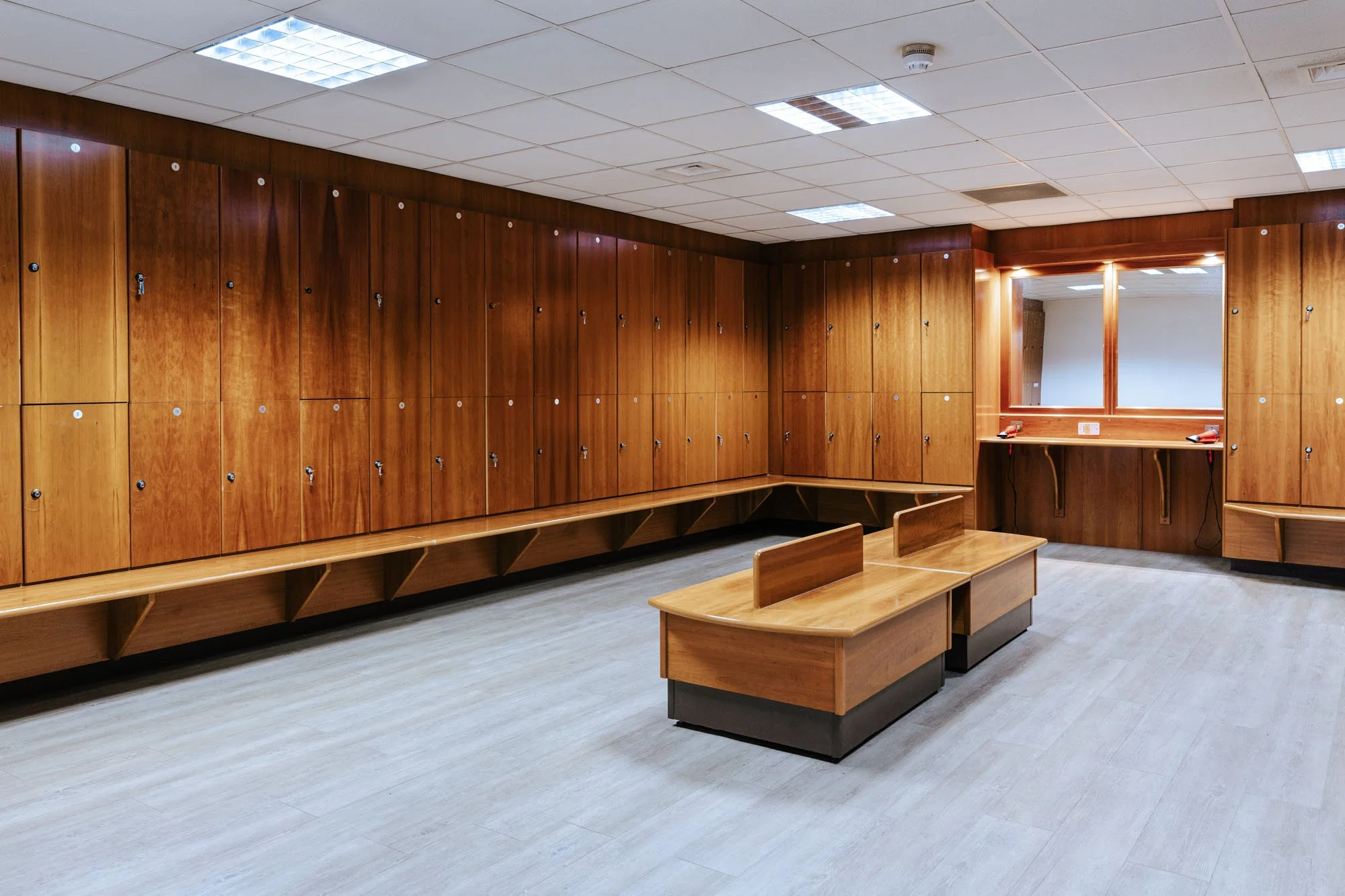 Interior of a wooden sauna with benches and a wall-mounted light