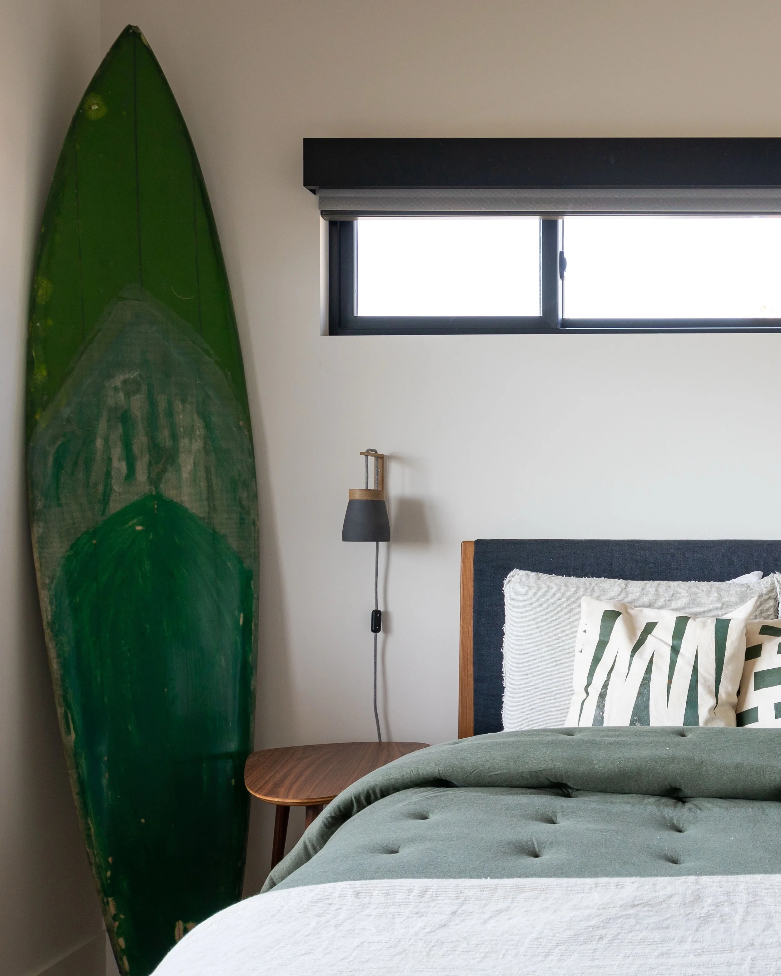 Surf&rsquo;s up.
Moody greens, a mix of wood tones, and a board that&rsquo;s clearly seen some things. This room doesn&rsquo;t try too hard, which is exactly why it works.
