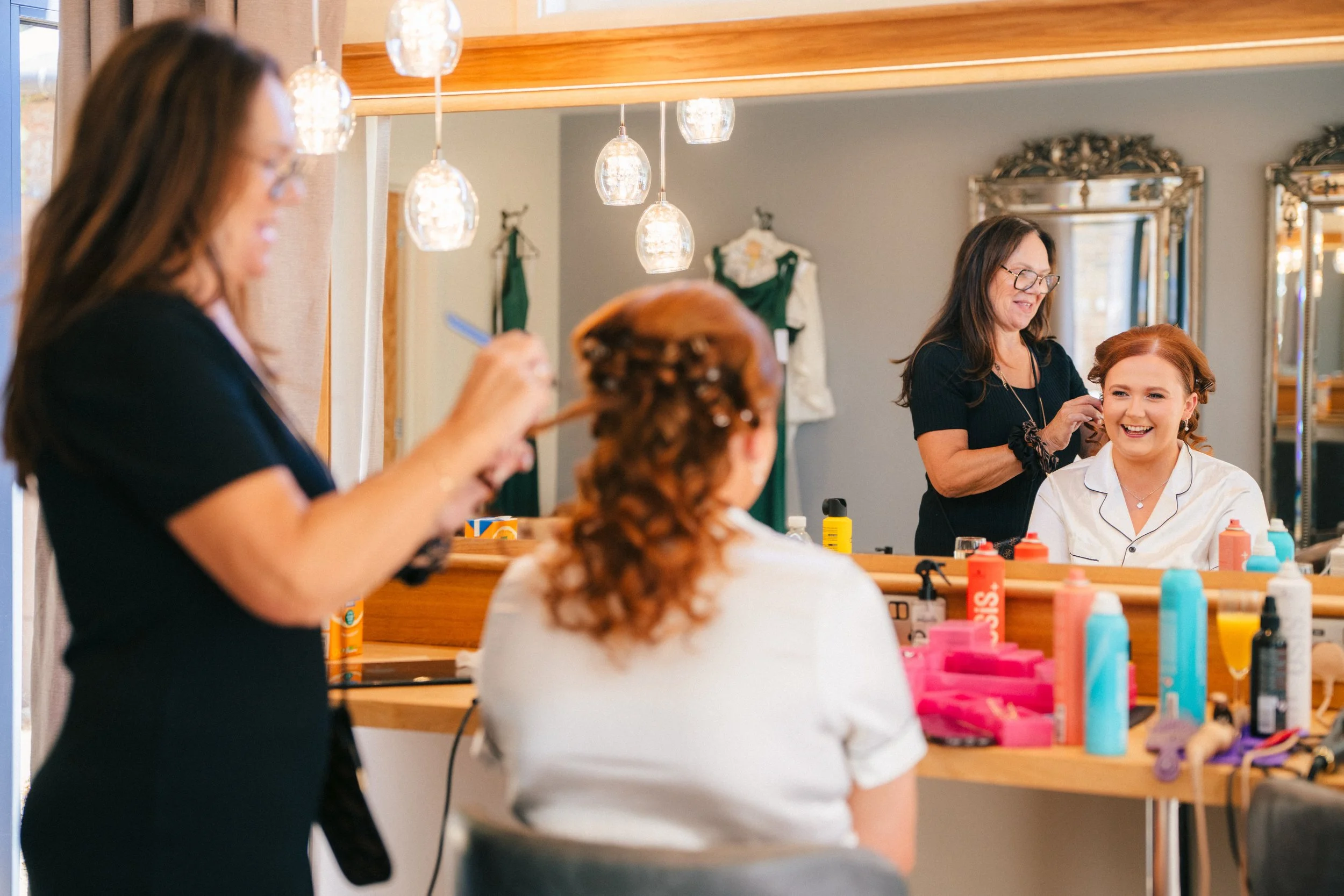 BREDENBURY COURT BARNS WEDDING PHOTOGRAPHER - bride having her hair done on the morning of her wedding
