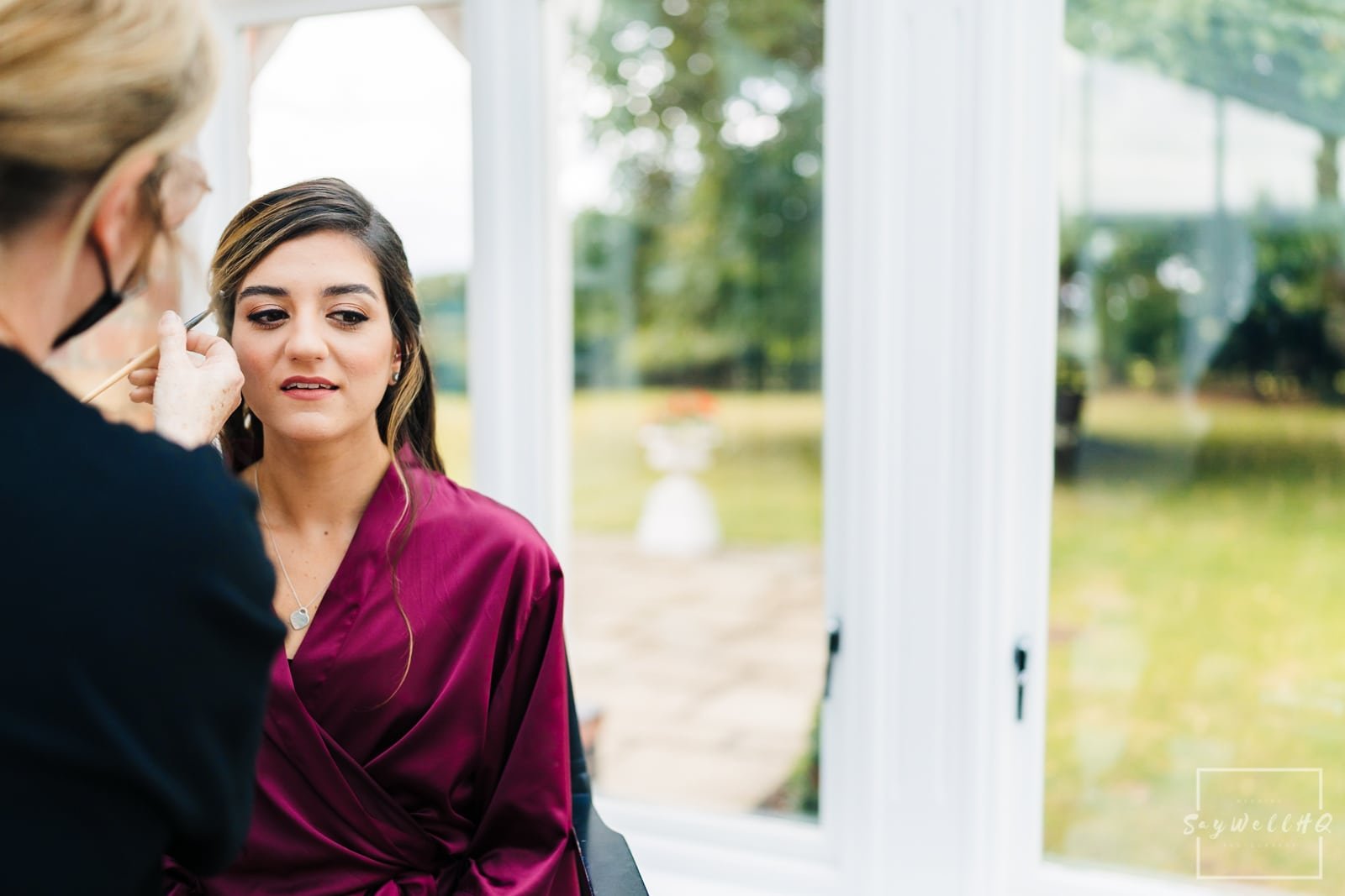 Langar Church Wedding Photography + Bridesmaid having her makeup done on the morning of her best friends wedding + www.saywellhq.co.uk + Relaxed Wedding Photography