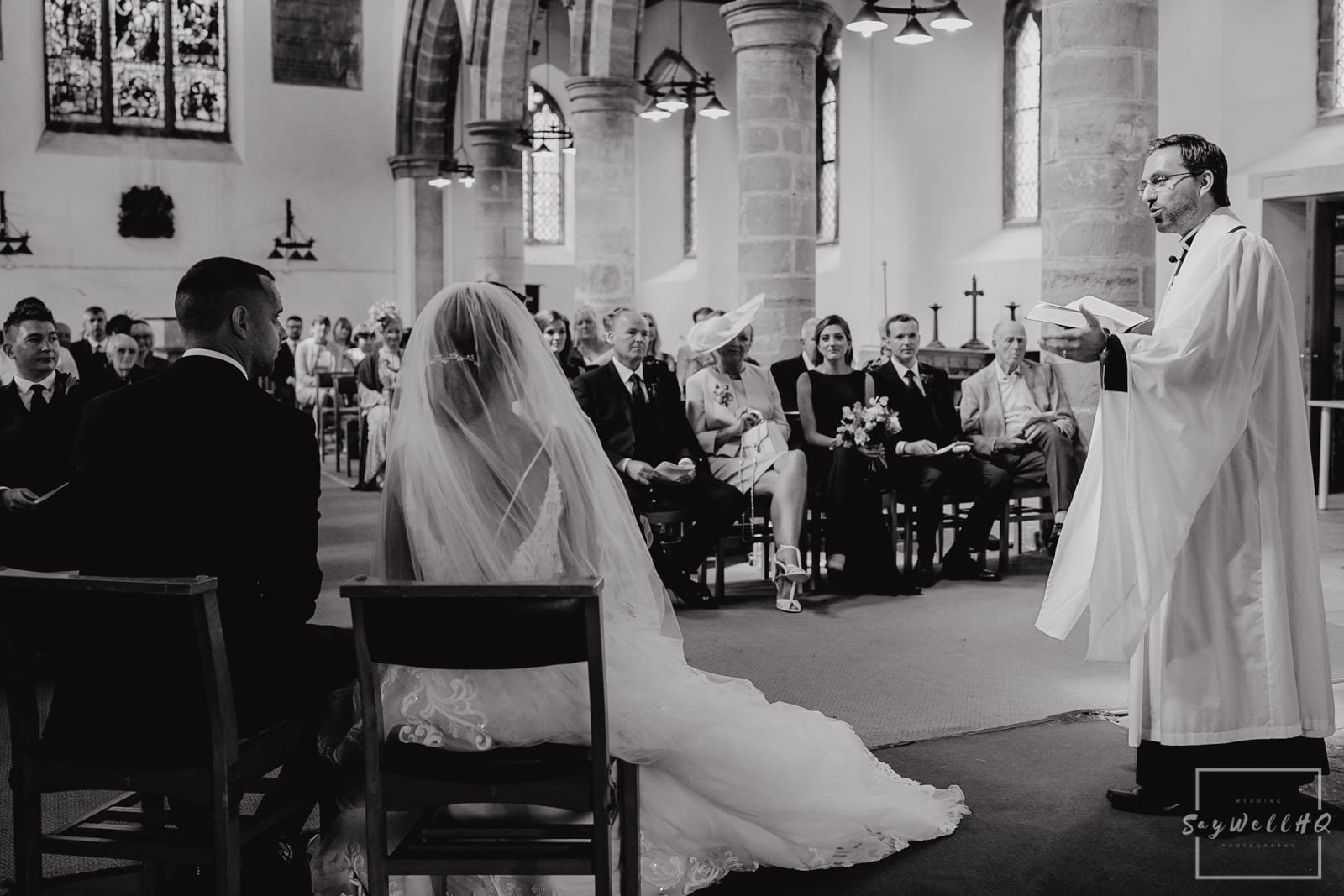 Church Wedding Photography + Vicar gives his guidance to the bride and groom during the wedding ceremony at a Church in Nottingham + www.saywellhq.co.uk + Relaxed Wedding Photography