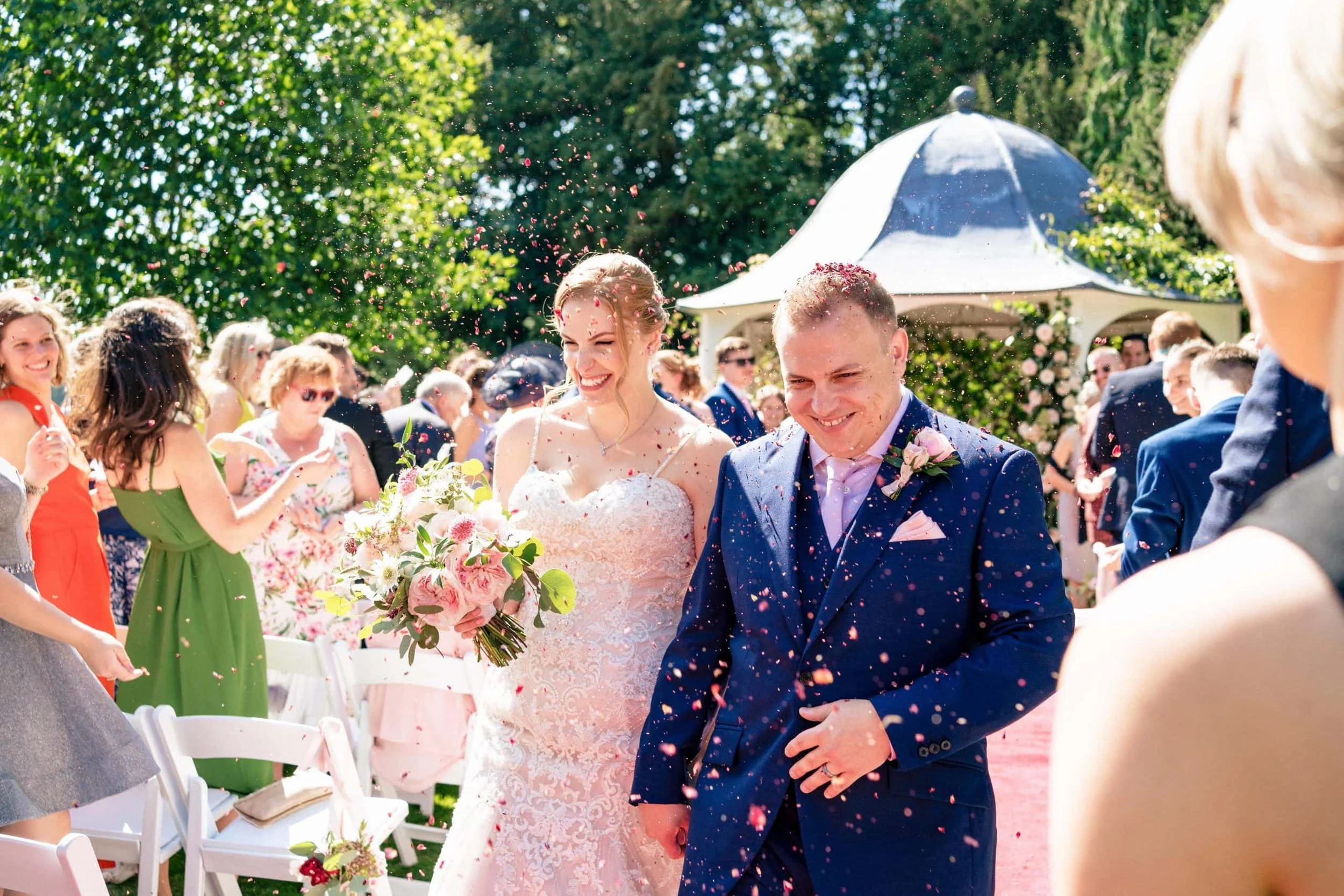 Prestwold Hall Wedding Venue - Bride and groom getting covered in confetti after their wedding