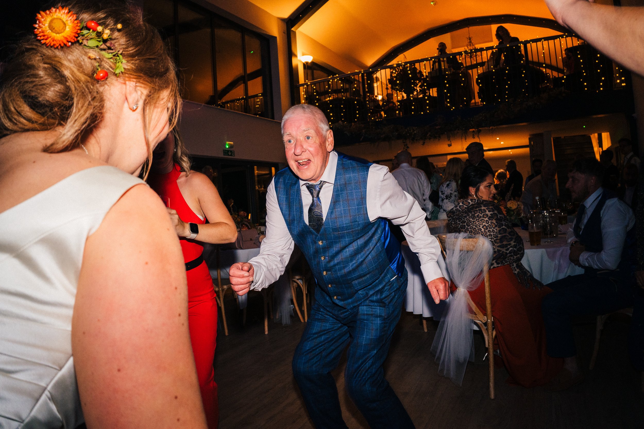 Oddhouse Farm Wedding Photography - father of the groom is up and dancing on the dancefloor at odd house farm