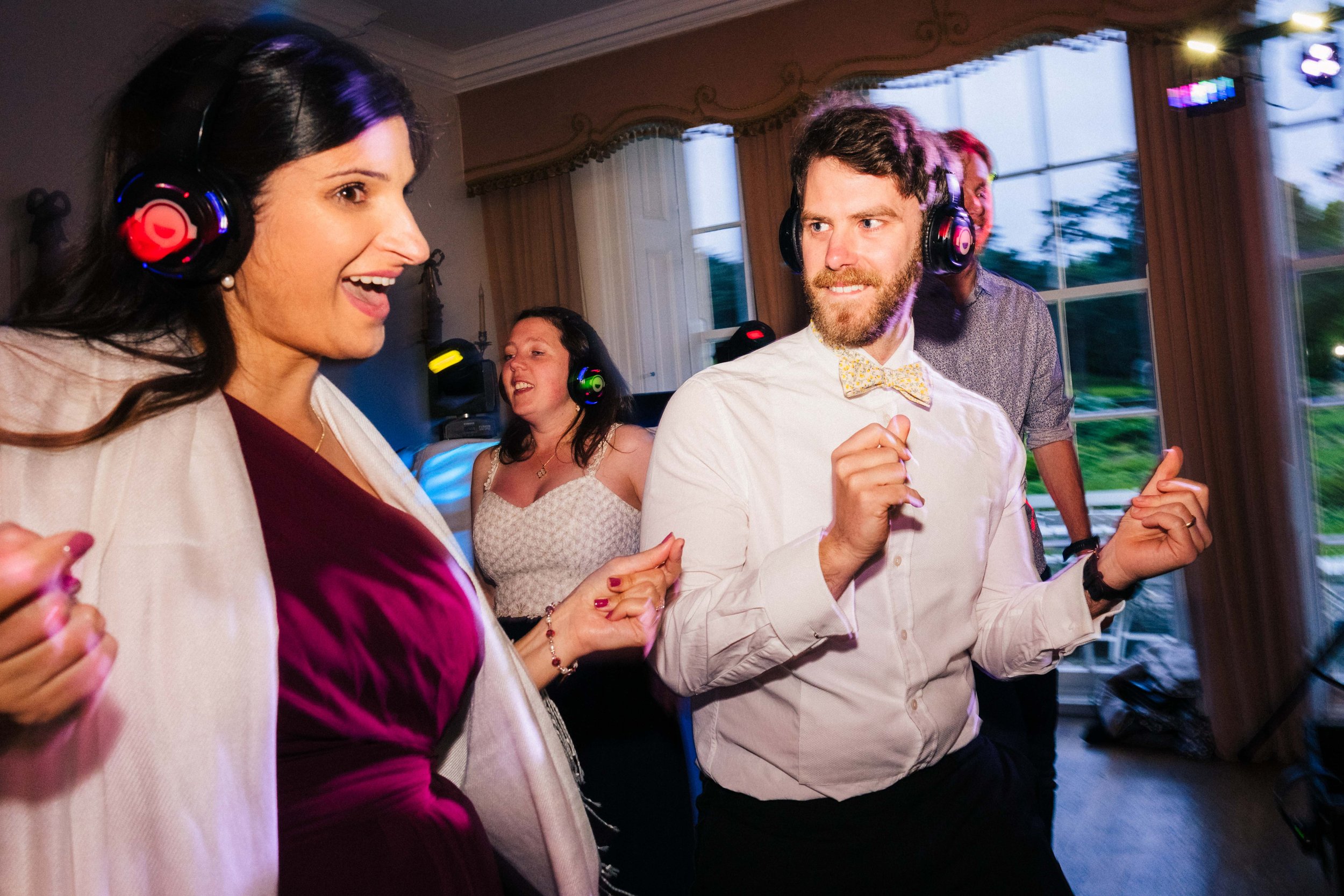 SUTTON BONINGTON HALL WEDDING PHOTOGRAPHY - wedding guests dancing during the silent disco