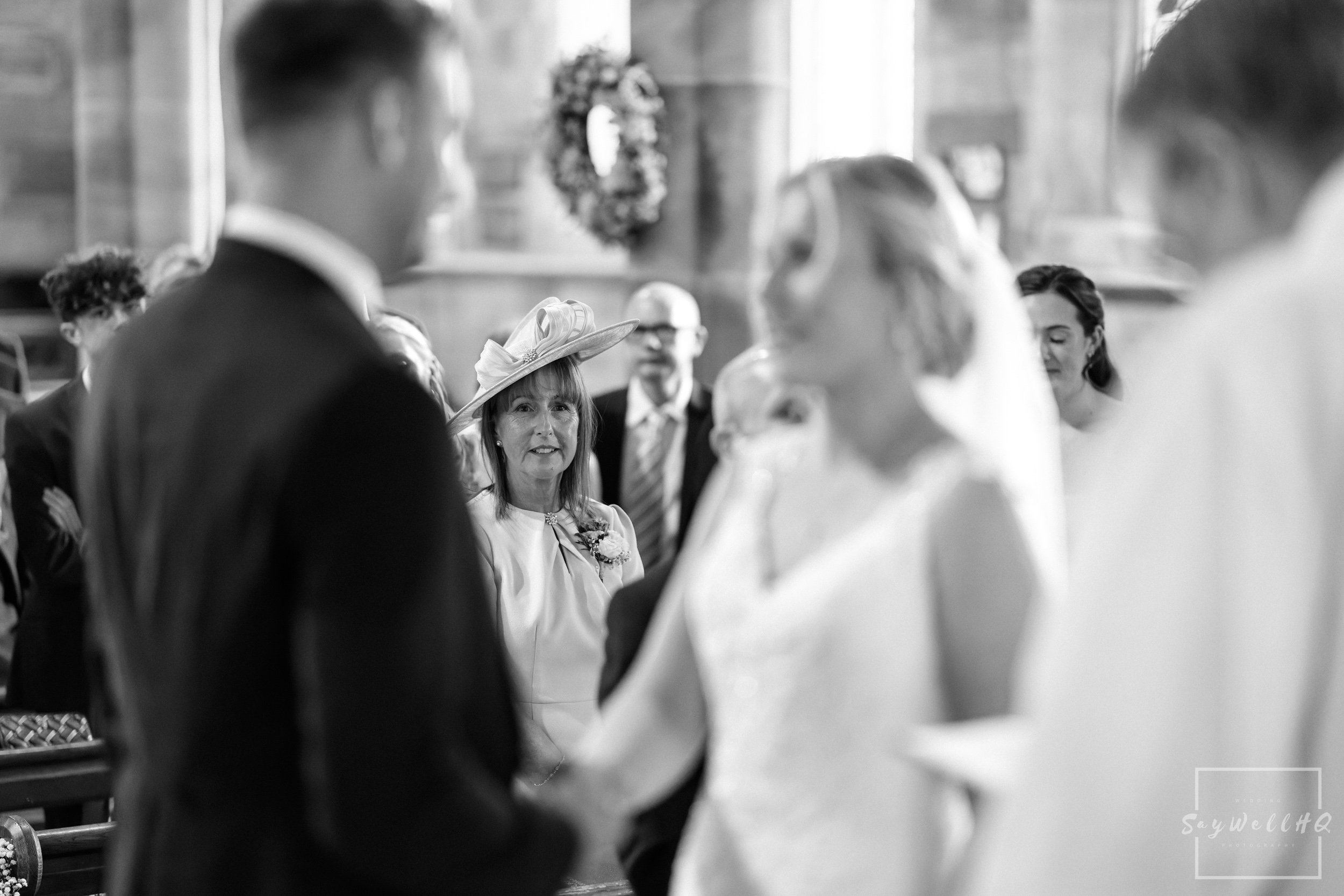 Sigma 85mm F1.4 DG DN for Wedding Photography | the brides mum looking at her daughter during the Church wedding ceremony
