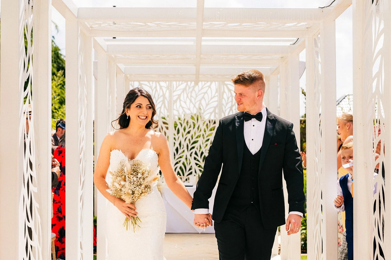 The bride and groom walking down the aisle following their outdoor ceremony at the WILDES INNS