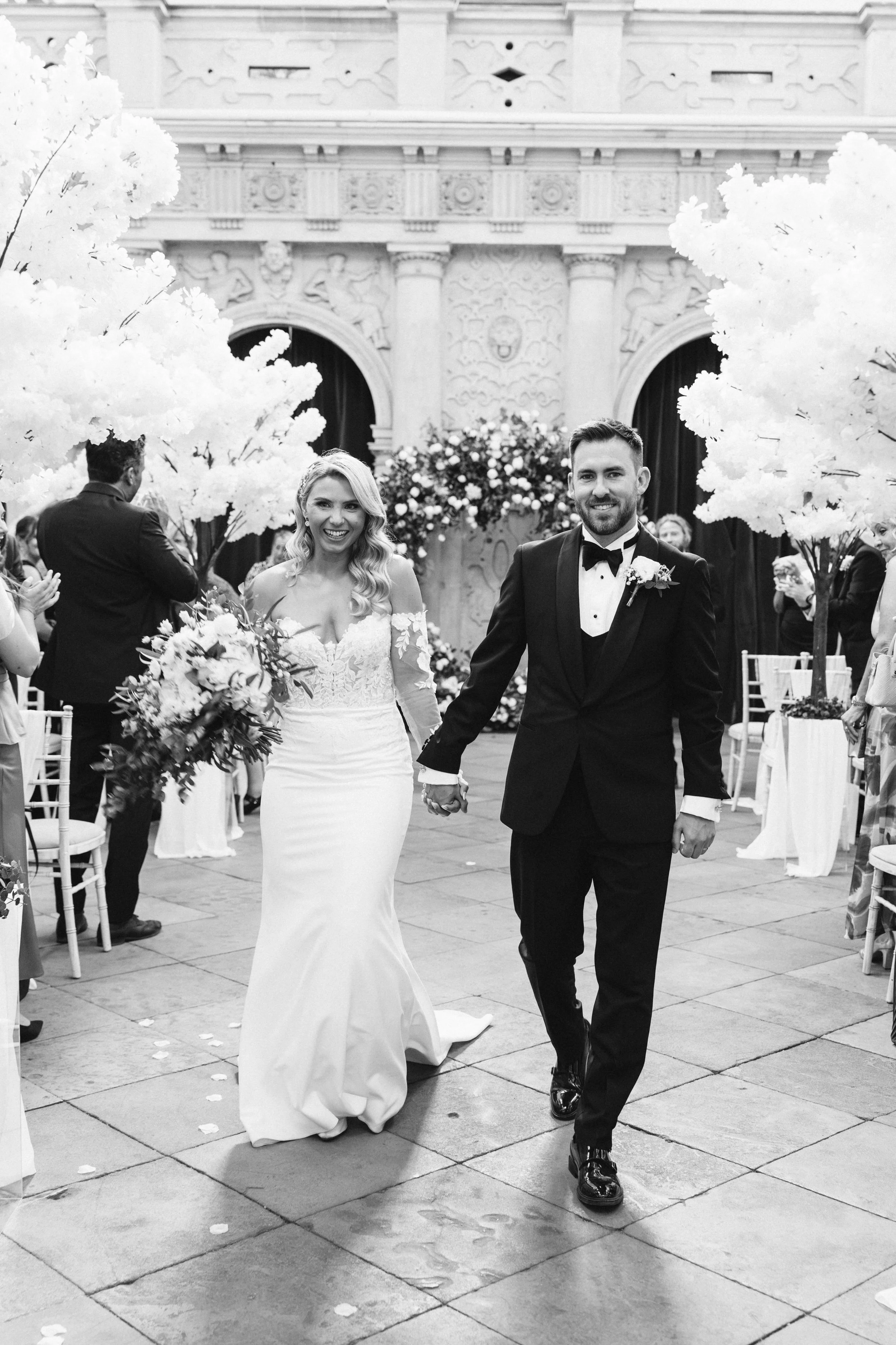 Bride and Groom Walking down the aisle at Wollaton Hall following their wedding ceremony in the Main Hall