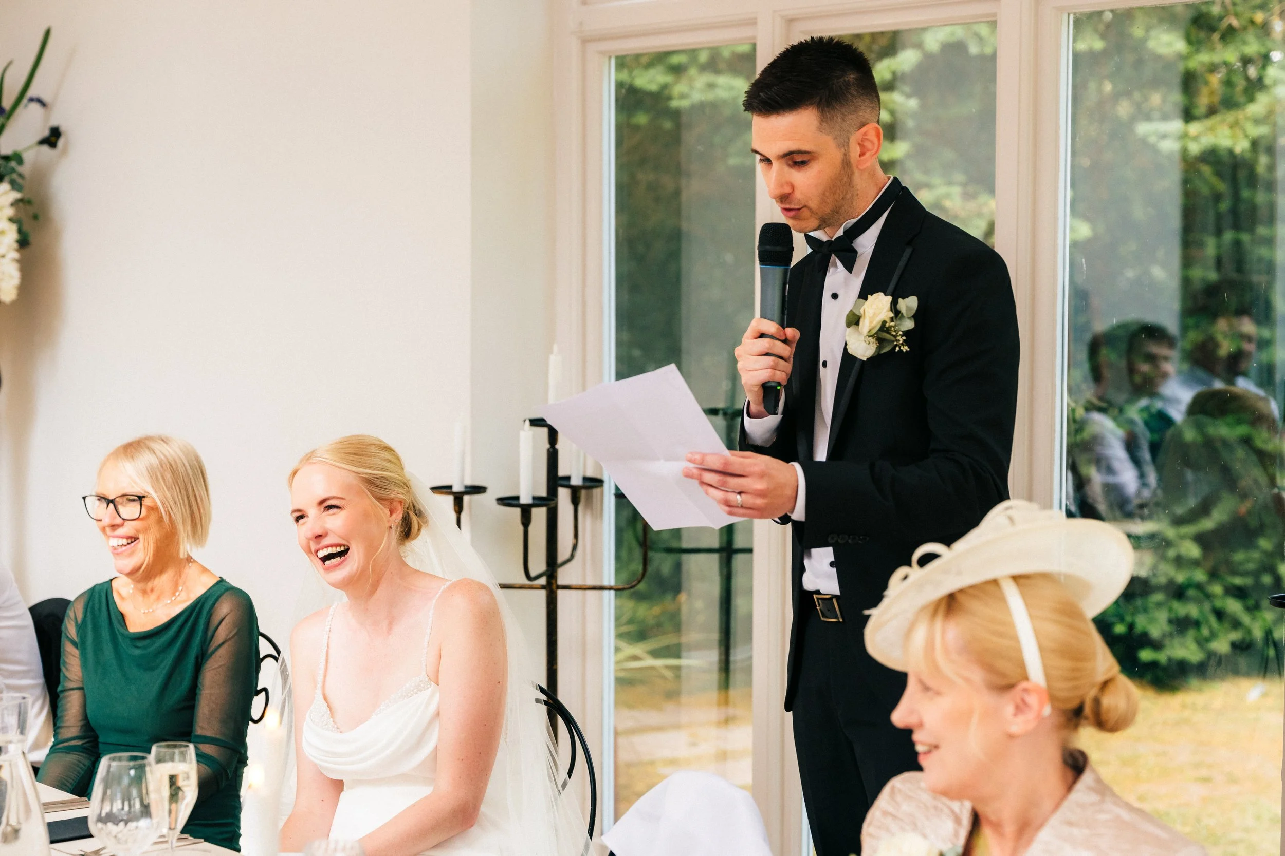 WOODBOROUGH HALL WEDDING PHOTOGRAPHER - bride laughing during the grooms wedding speech
