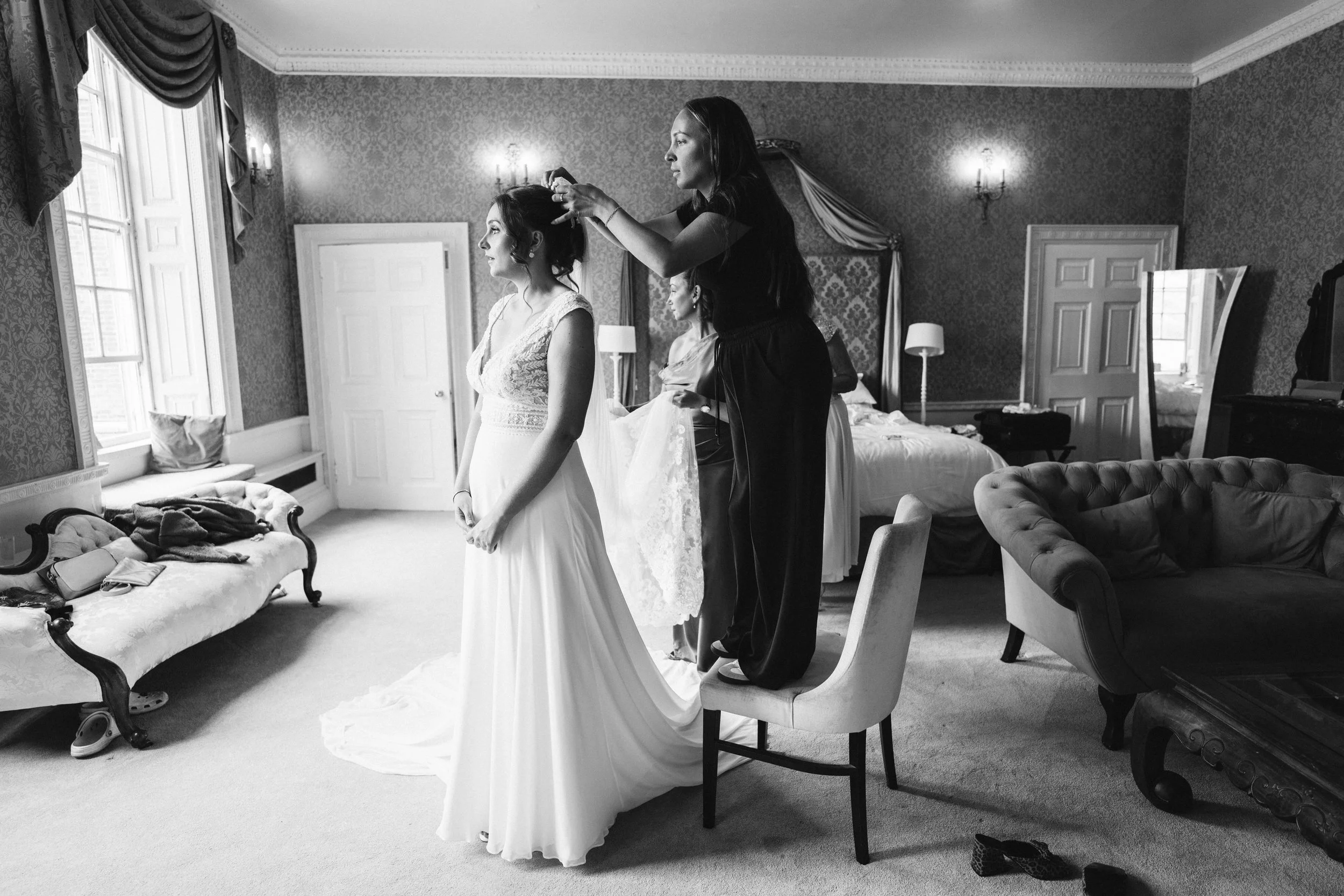 Bride having her veil put in on the morning of her wedding at Colwick Hall