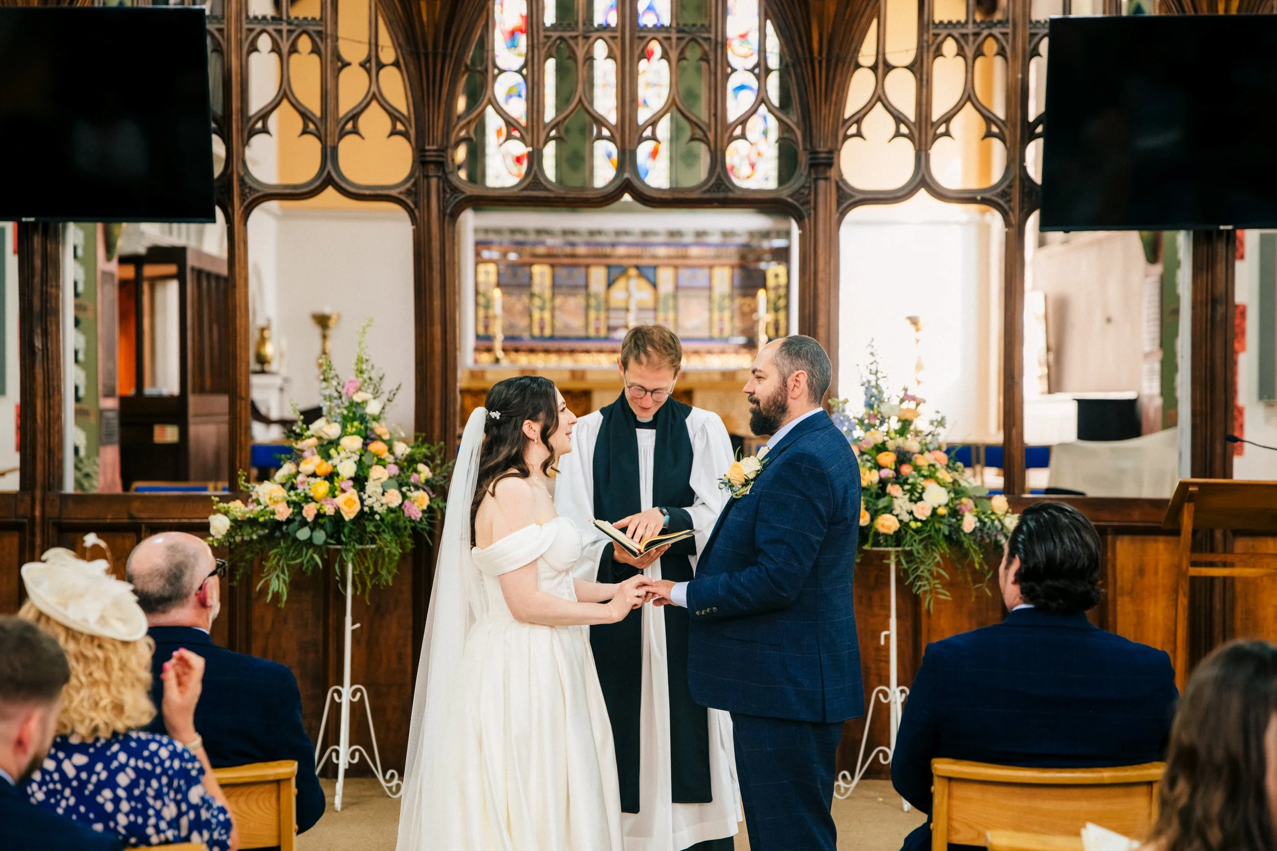 Lincoln Church Wedding Photography | Bride and groom exchanging their wedding rings