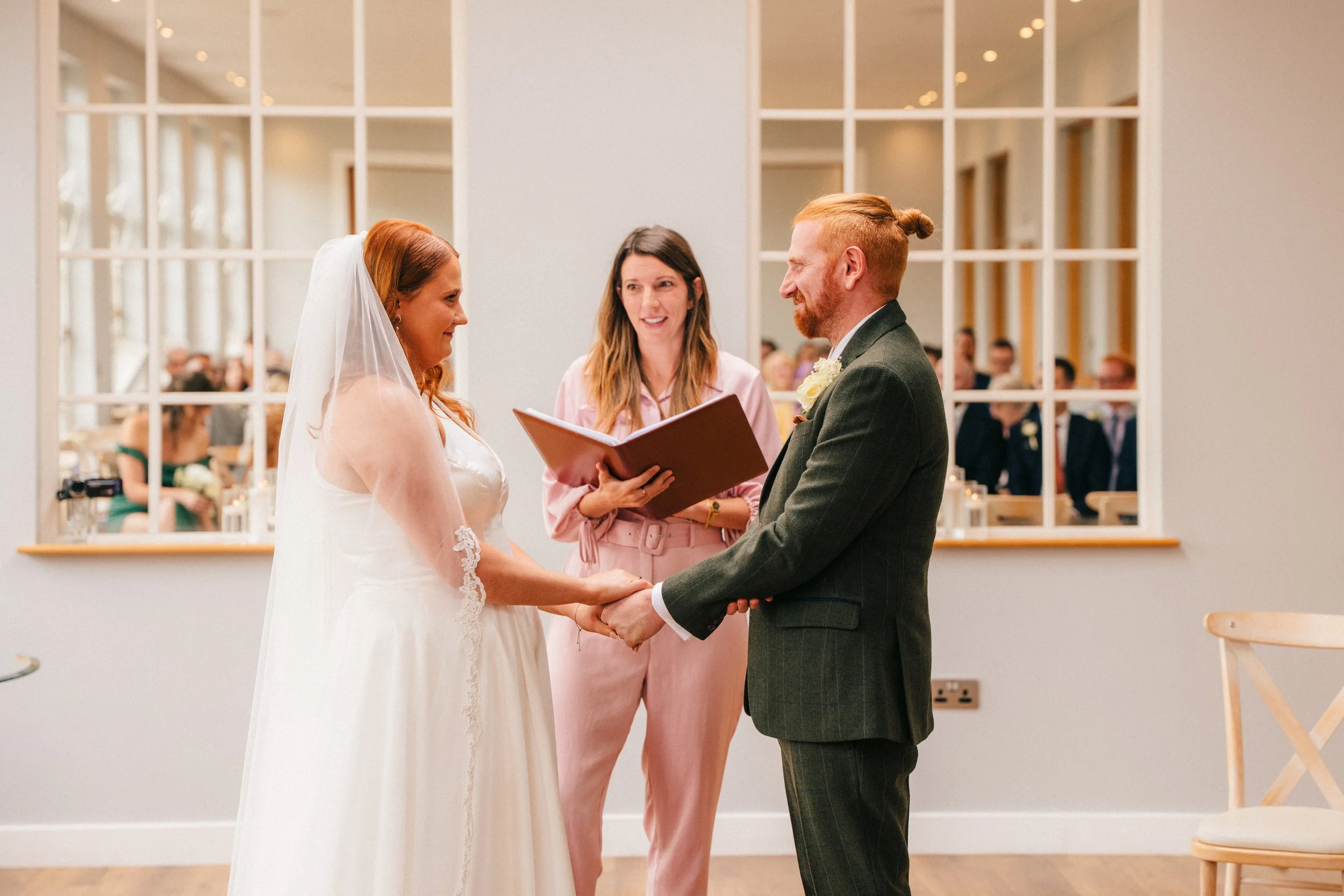 BREDENBURY COURT BARNS WEDDING PHOTOGRAPHER - bride and groom holding hands during the Humanist wedding ceremony