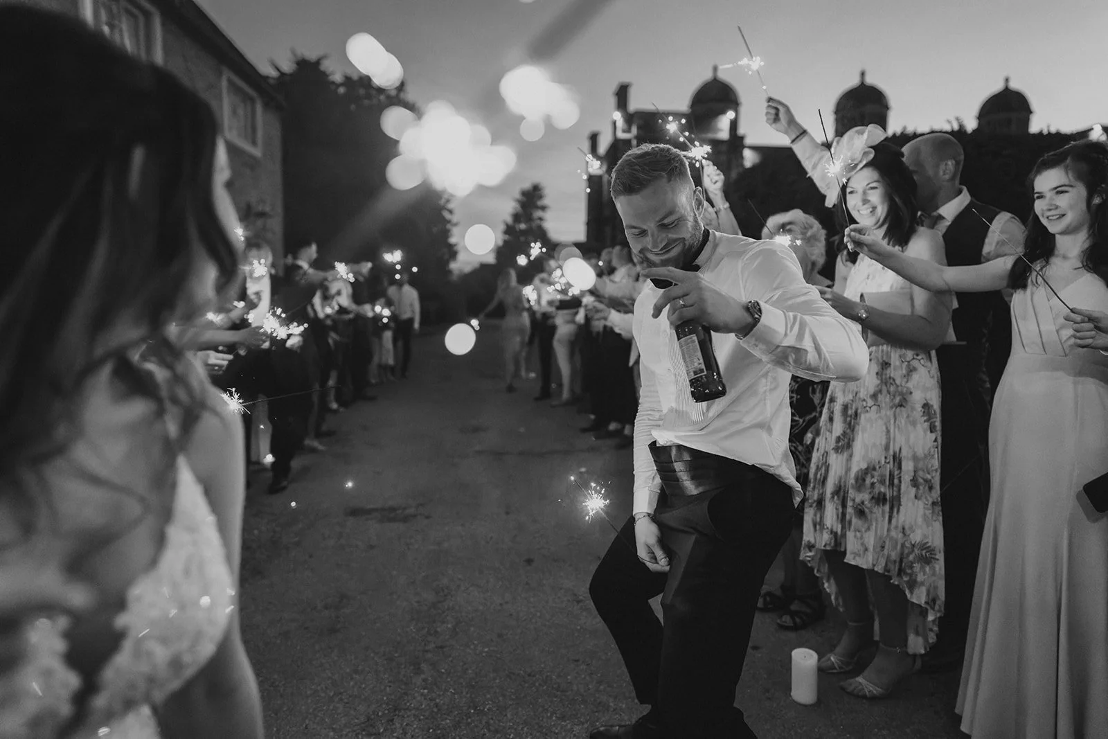 Doddington Hall Wedding Venue Guide - bride and groom sparkler exit infront of the coach house at Doddington Hall