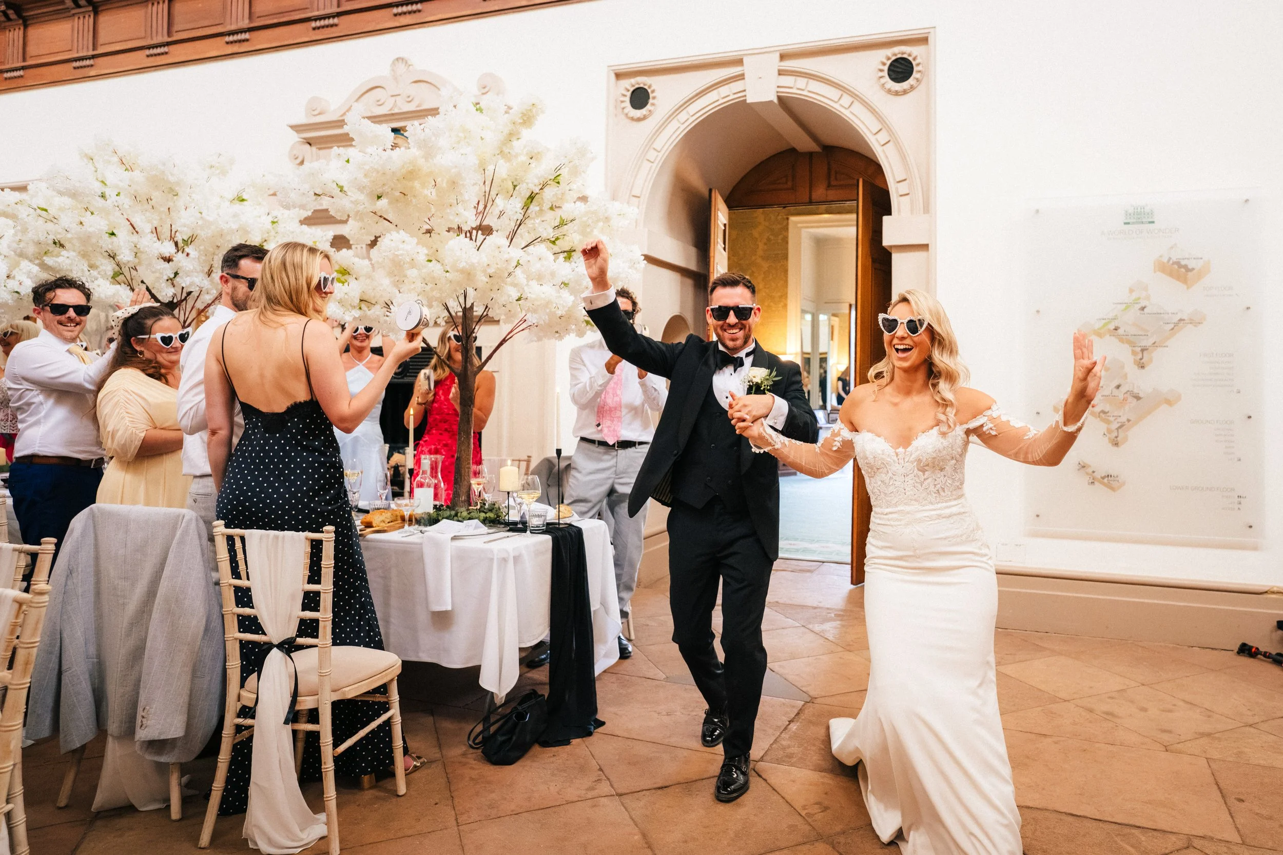 Bride and groom entering the wedding breakfast room at Wollaton Hall