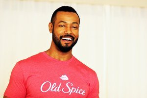 Person wearing a red "Old Spice" T-shirt smiling.