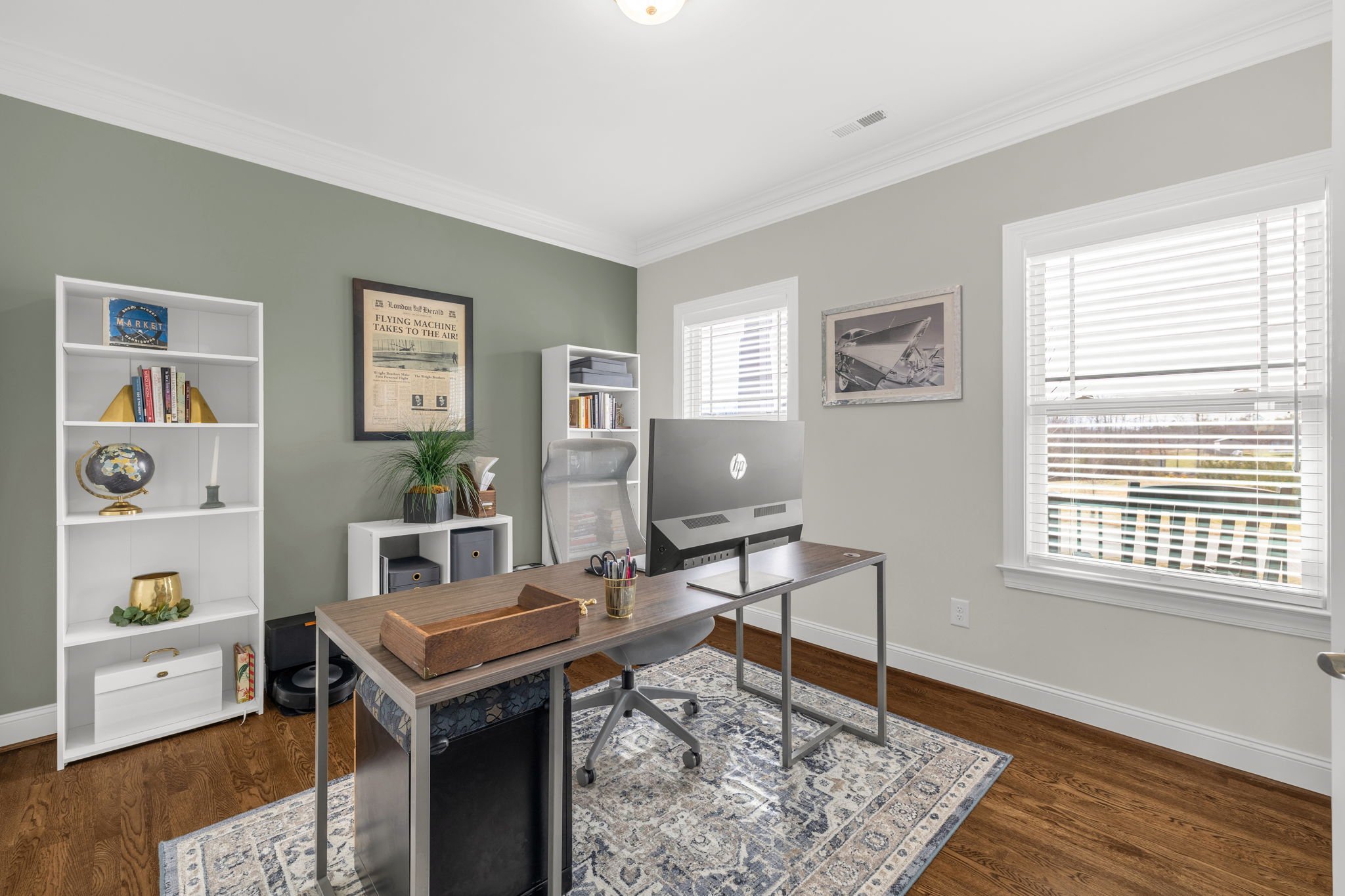 First-floor office with sage accent wall and crown molding at 8012 NW Meadows Drive, Stokesdale, NC 27357. Listed by Delia Knight, REALTOR® with Howard Hanna Allen Tate Real Estate.