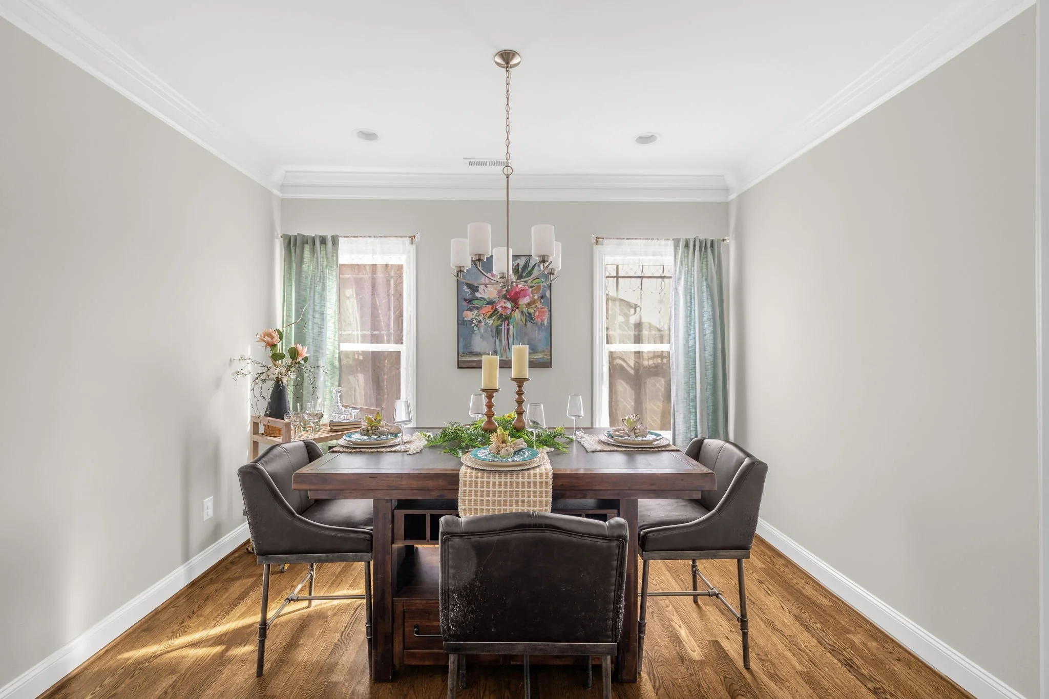 Formal dining room with chandelier and crown molding at 8012 NW Meadows Drive, Stokesdale, NC 27357. Listed by Delia Knight, REALTOR® with Howard Hanna Allen Tate Real Estate.