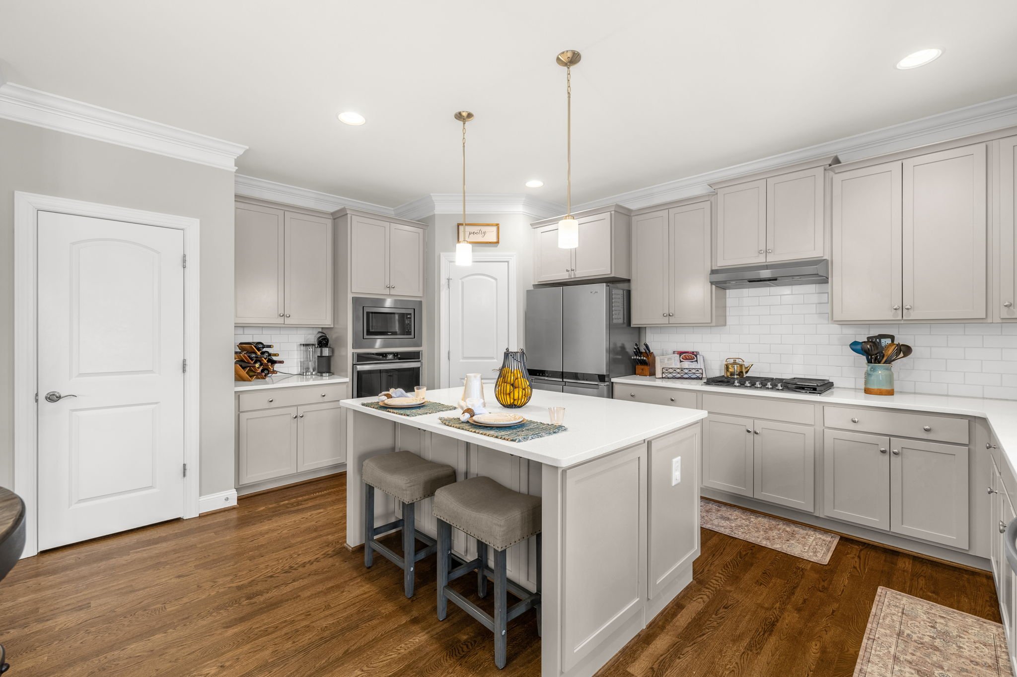 Kitchen with gas range and subway tile at 8012 NW Meadows Drive, Stokesdale, NC 27357. Listed by Delia Knight, REALTOR® with Howard Hanna Allen Tate Real Estate.