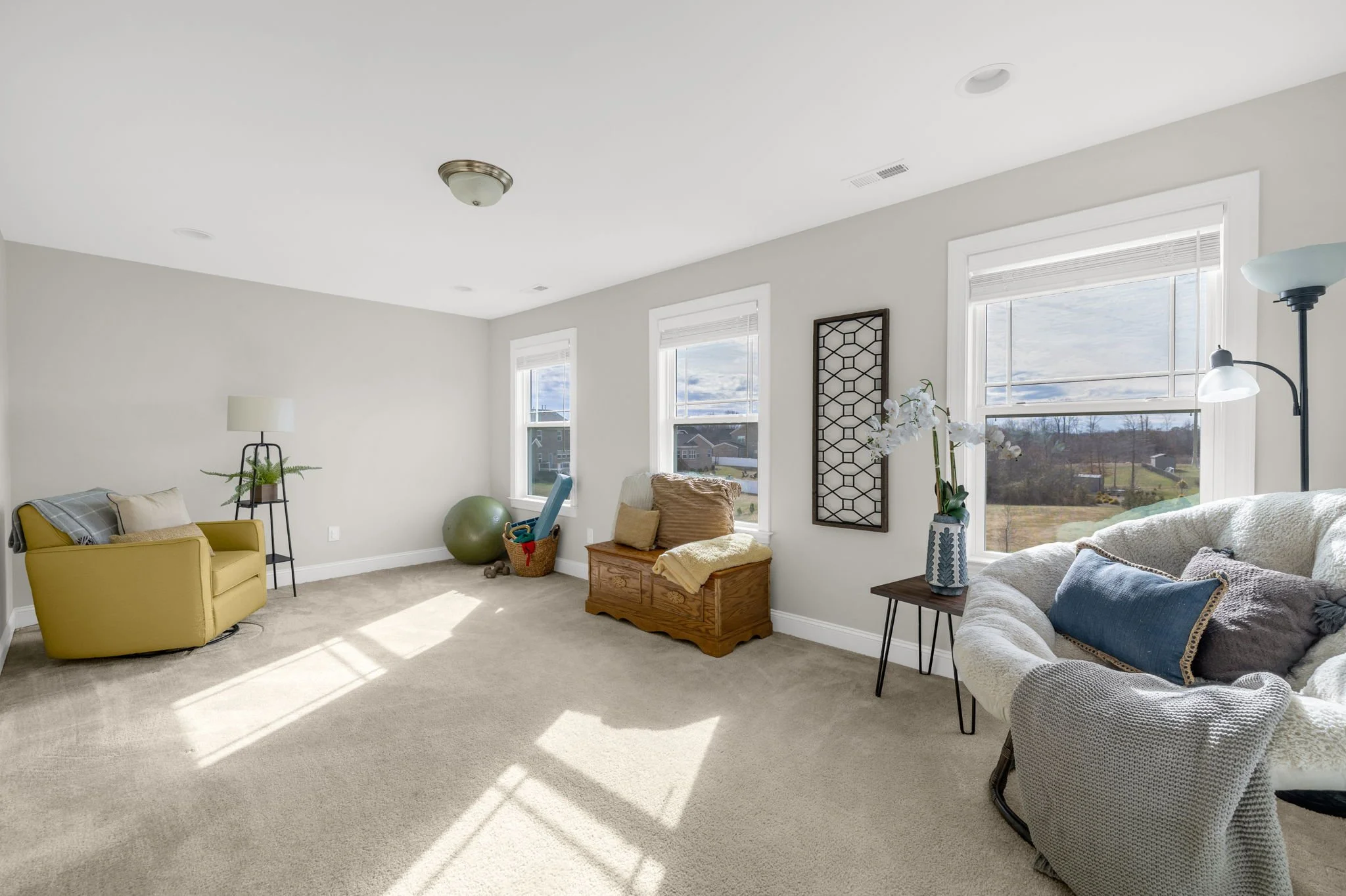 Upstairs bonus room with natural light at 8012 NW Meadows Drive, Stokesdale, NC 27357. Listed by Delia Knight, REALTOR® with Howard Hanna Allen Tate Real Estate.