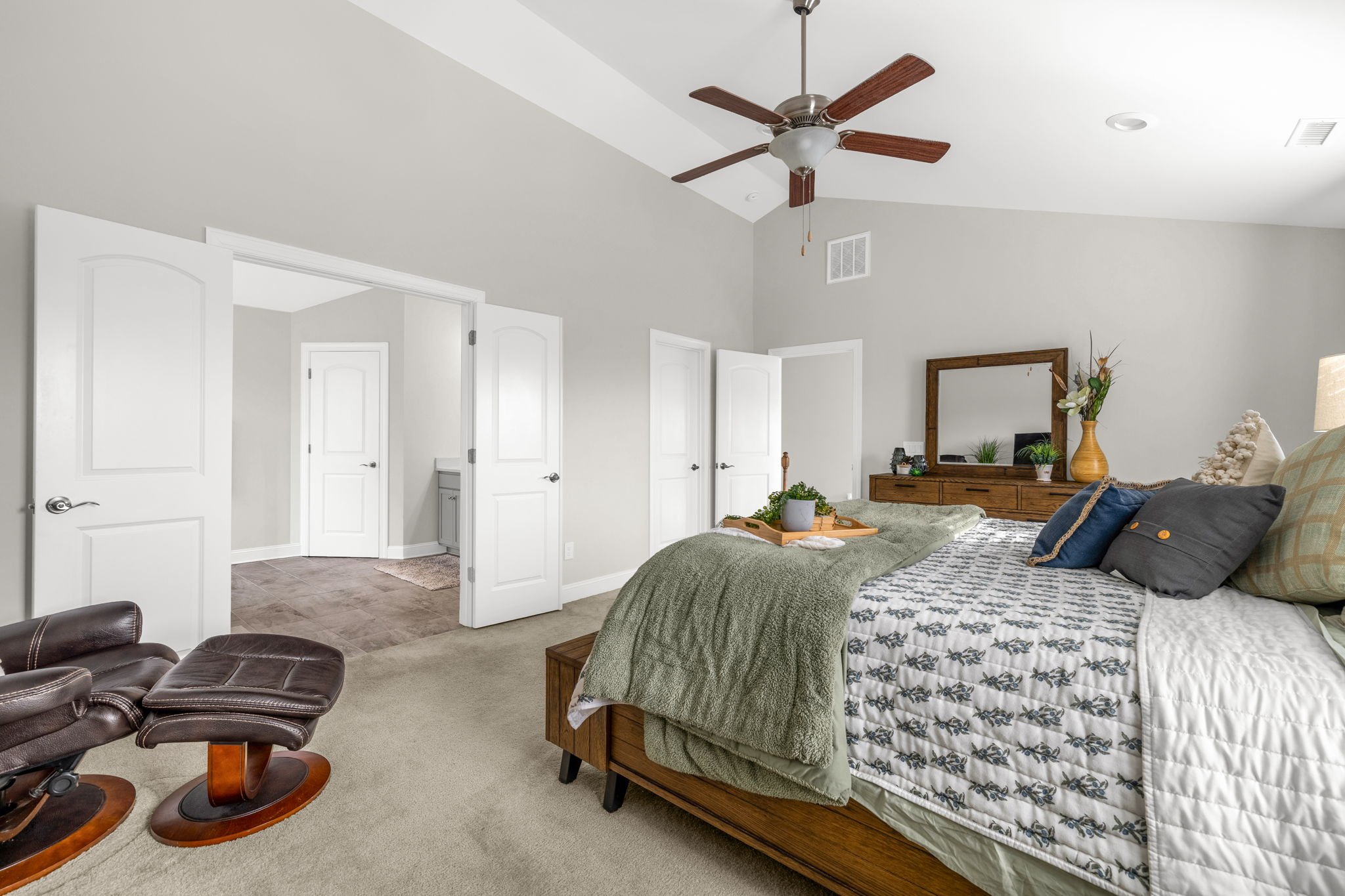 Primary bedroom with double closets and en suite entry at 8012 NW Meadows Drive, Stokesdale, NC 27357. Listed by Delia Knight, REALTOR® with Howard Hanna Allen Tate Real Estate.