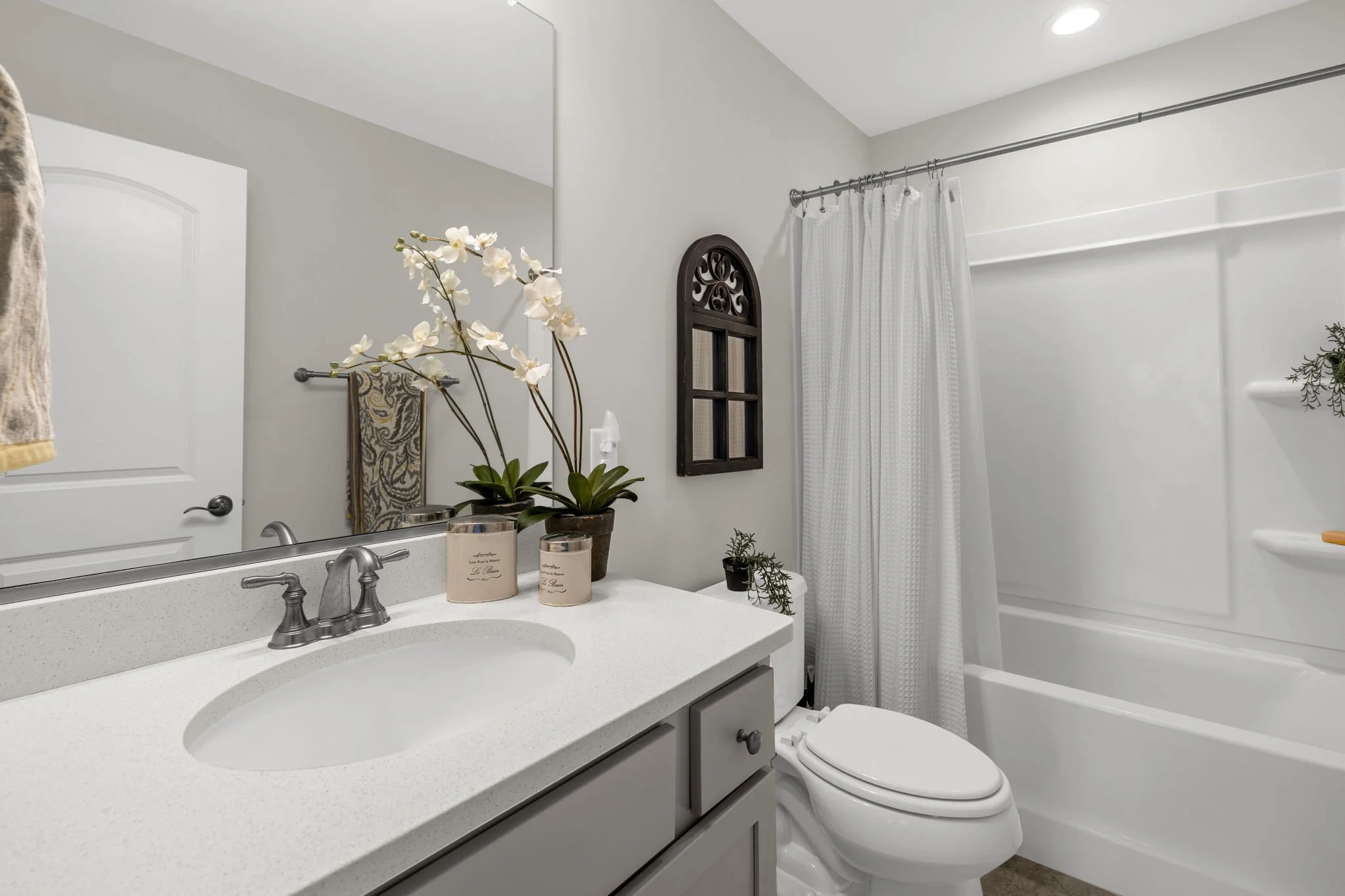 Hall bathroom with tub-shower and single vanity at 8012 NW Meadows Drive, Stokesdale, NC 27357. Listed by Delia Knight, REALTOR® with Howard Hanna Allen Tate Real Estate.