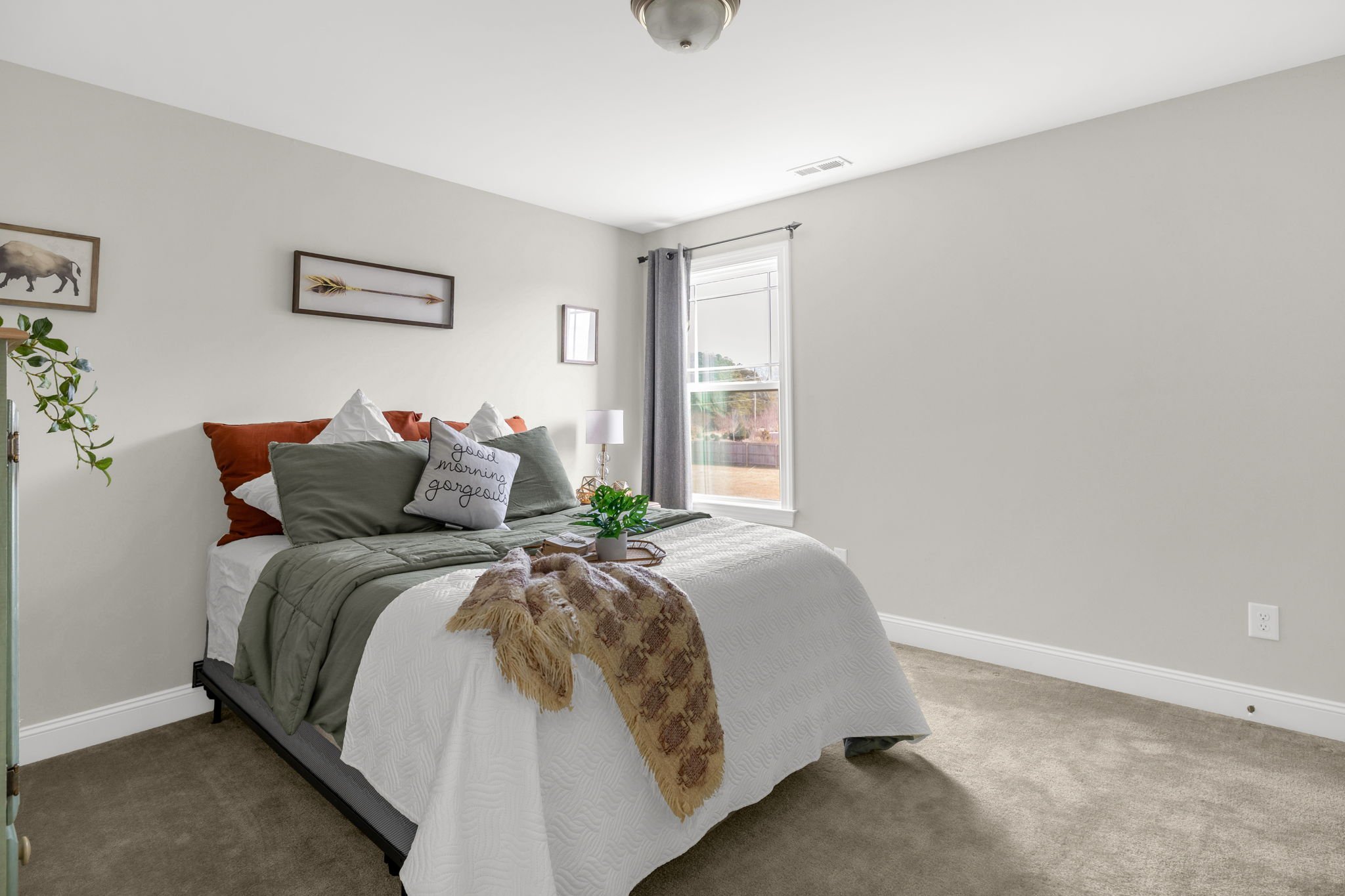 Bedroom three with carpet and natural light at 8012 NW Meadows Drive, Stokesdale, NC 27357. Listed by Delia Knight, REALTOR® with Howard Hanna Allen Tate Real Estate.
