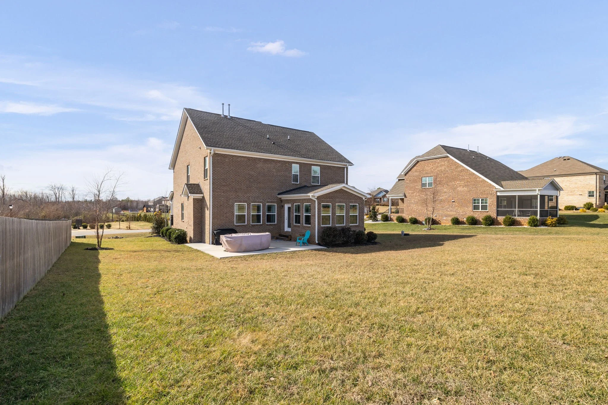 Full rear view with fenced backyard at 8012 NW Meadows Drive, Stokesdale, NC 27357. Listed by Delia Knight, REALTOR® with Howard Hanna Allen Tate Real Estate.
